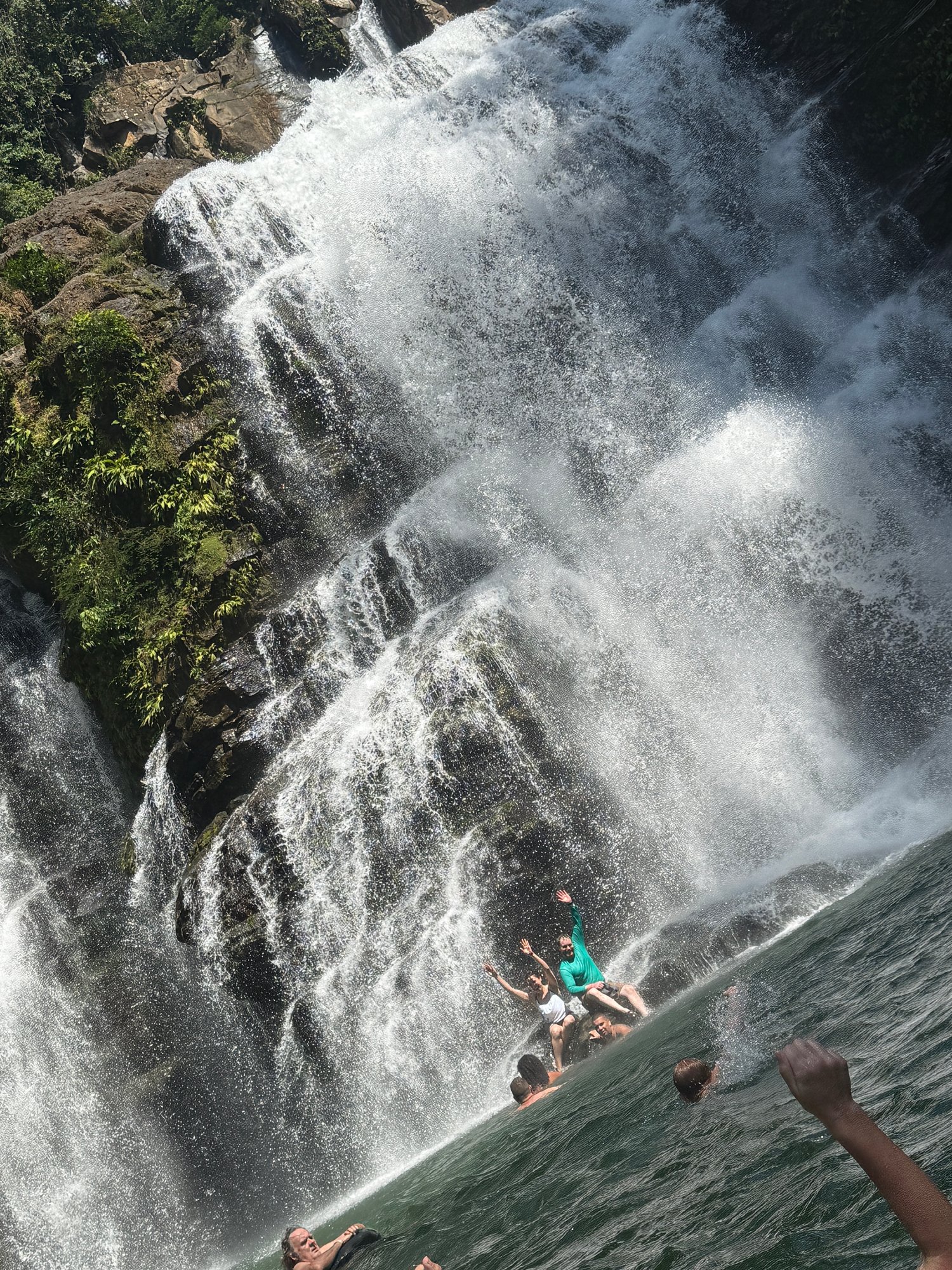 People at the base of a cascading waterfall — the philosophy in action
