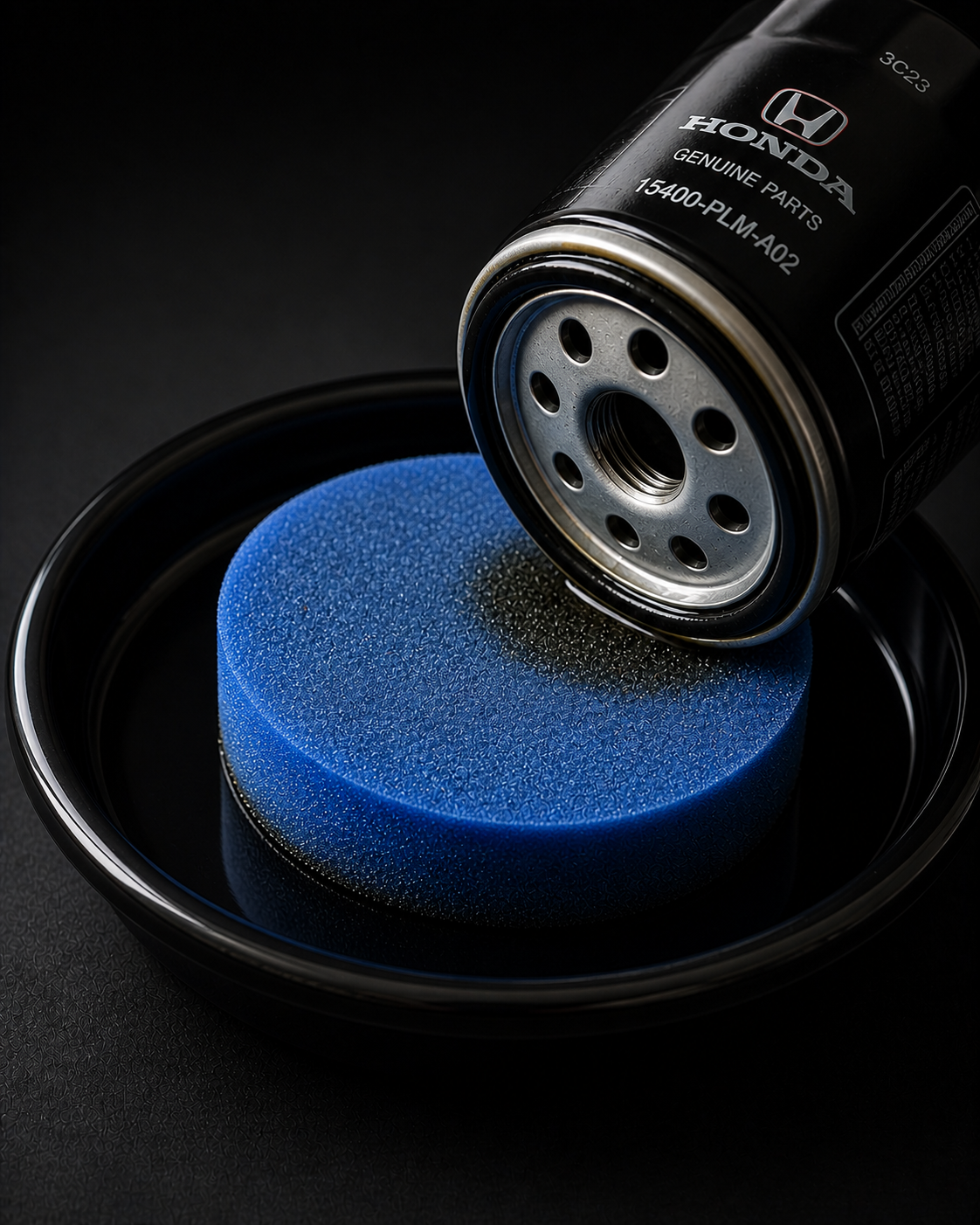 Honda oil filter O-ring being pressed onto the OPS Tray blue pad — product in use