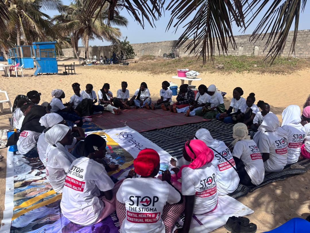 Sheeac circle discussion — participants in Stop the Stigma Mental Health is Menstrual Health t-shirts at community health workshop, The Gambia