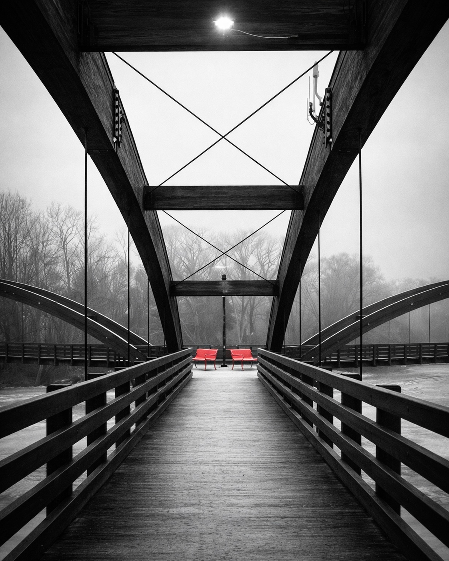 The Tridge — three-way footbridge in Midland, Michigan, red benches at the end, selective color photography by Craig Moyers