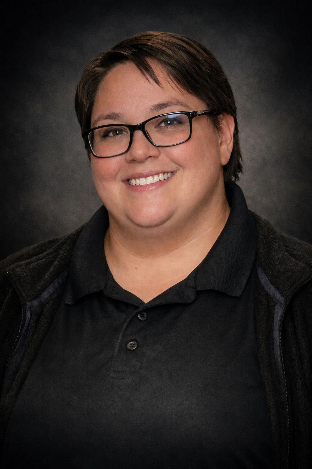 Standard professional headshot against a dark backdrop — corporate headshot by Sidewalk Stories Photography, Bay City Michigan