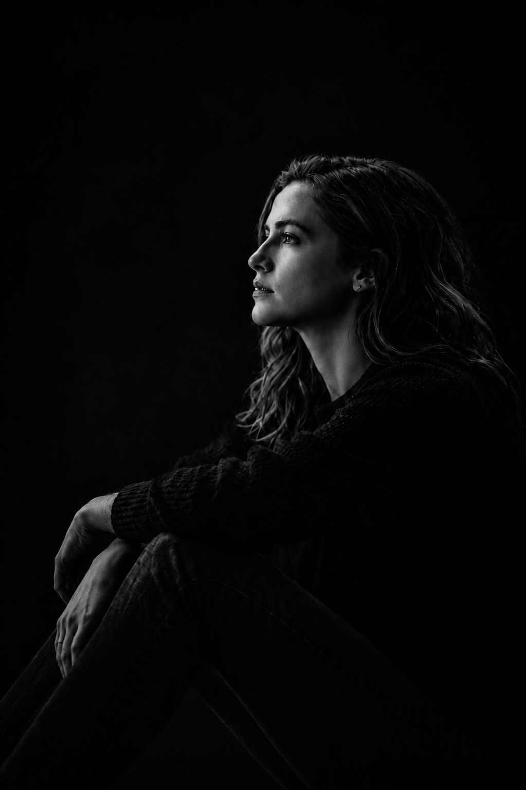 Dramatic B&W legacy portrait with edge lighting and deep shadows by Sidewalk Stories Photography
