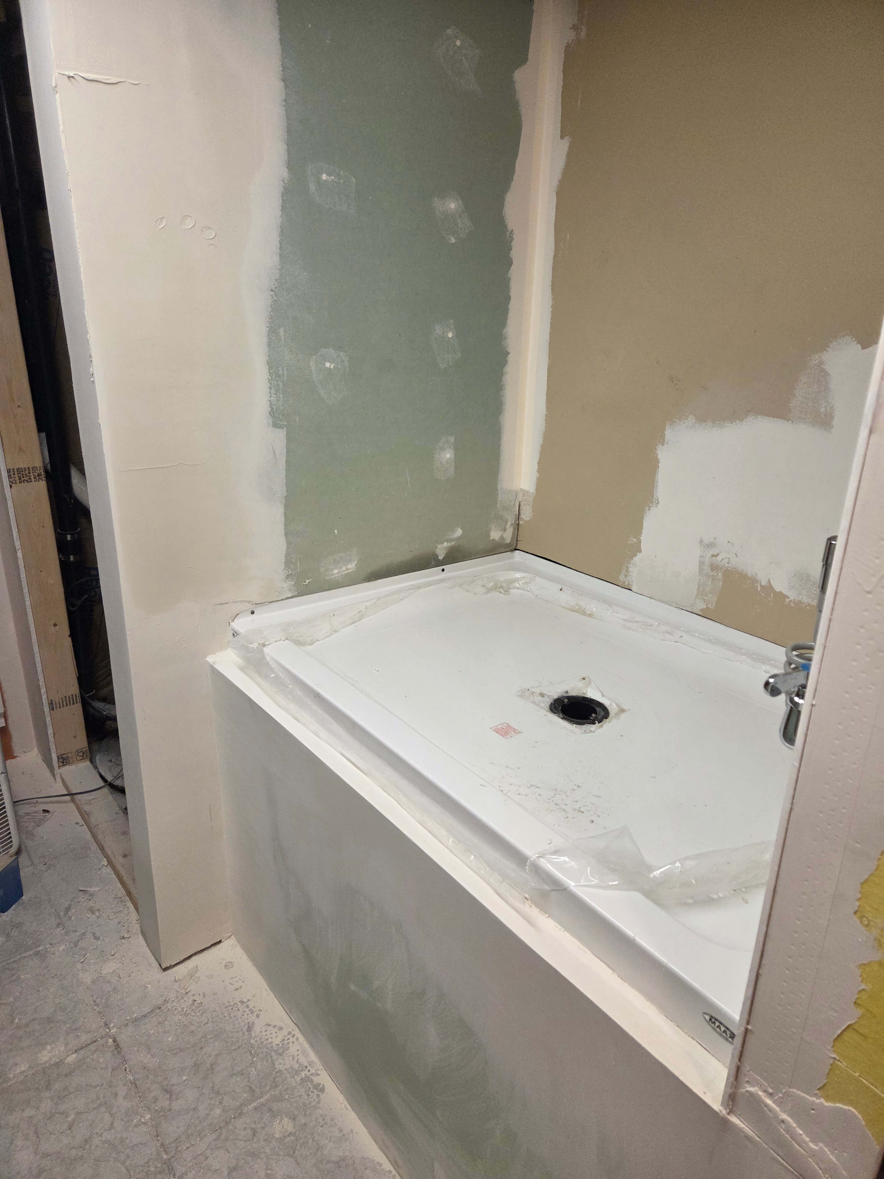 Sheetrock installed around shower pan