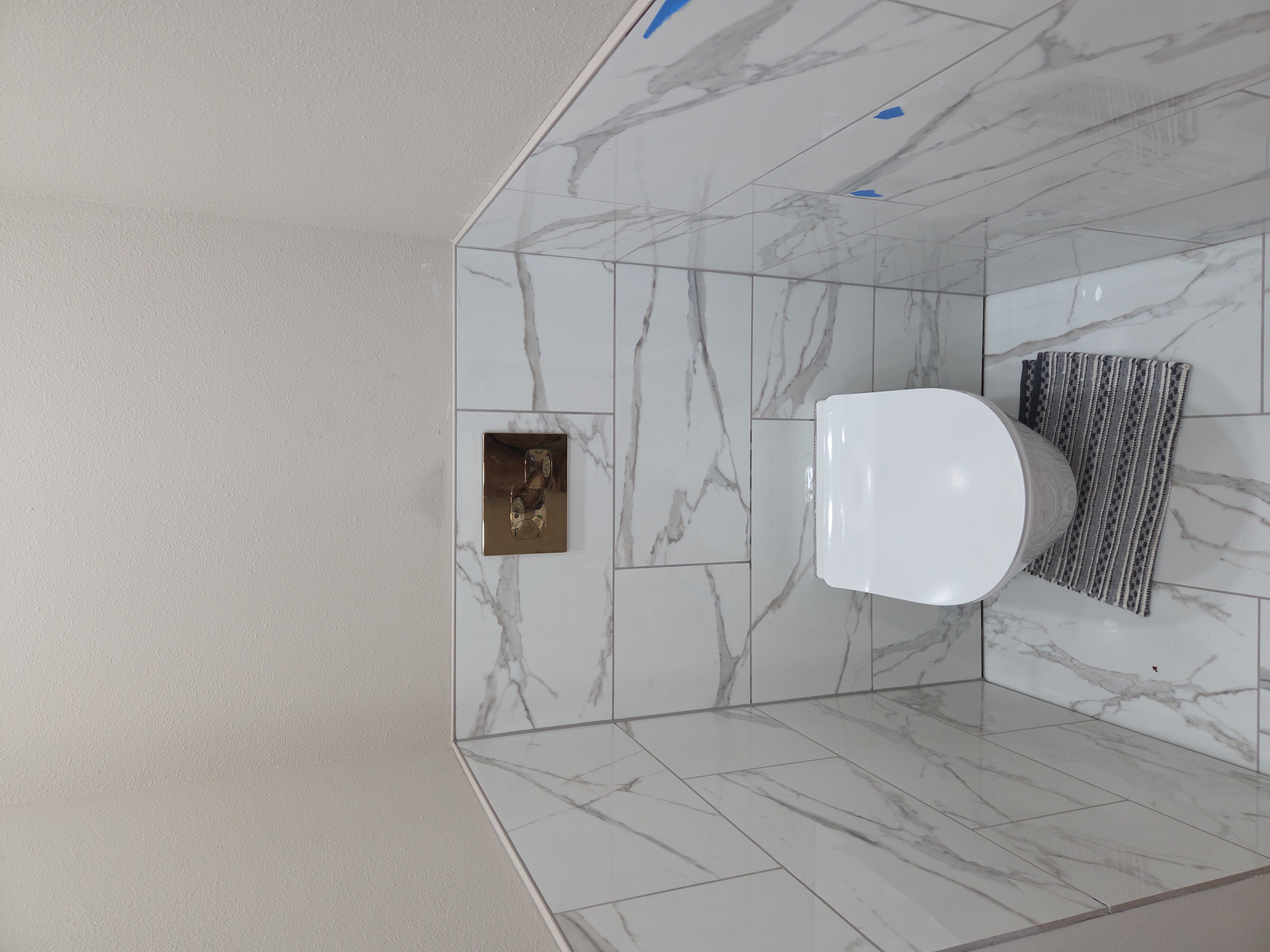 Wall-hung toilet with marble tile