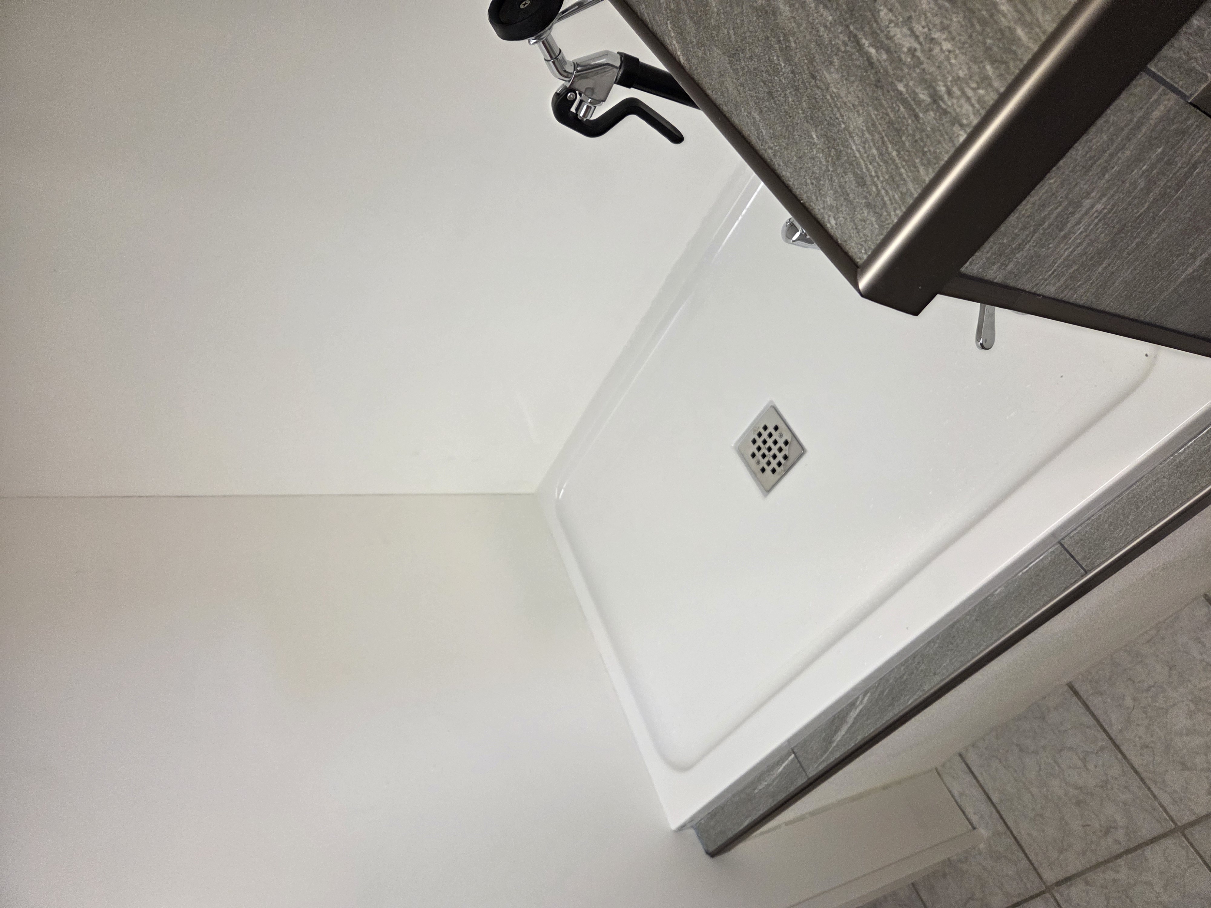 Wide angle showing full pan, tile trim edge, and gate rail