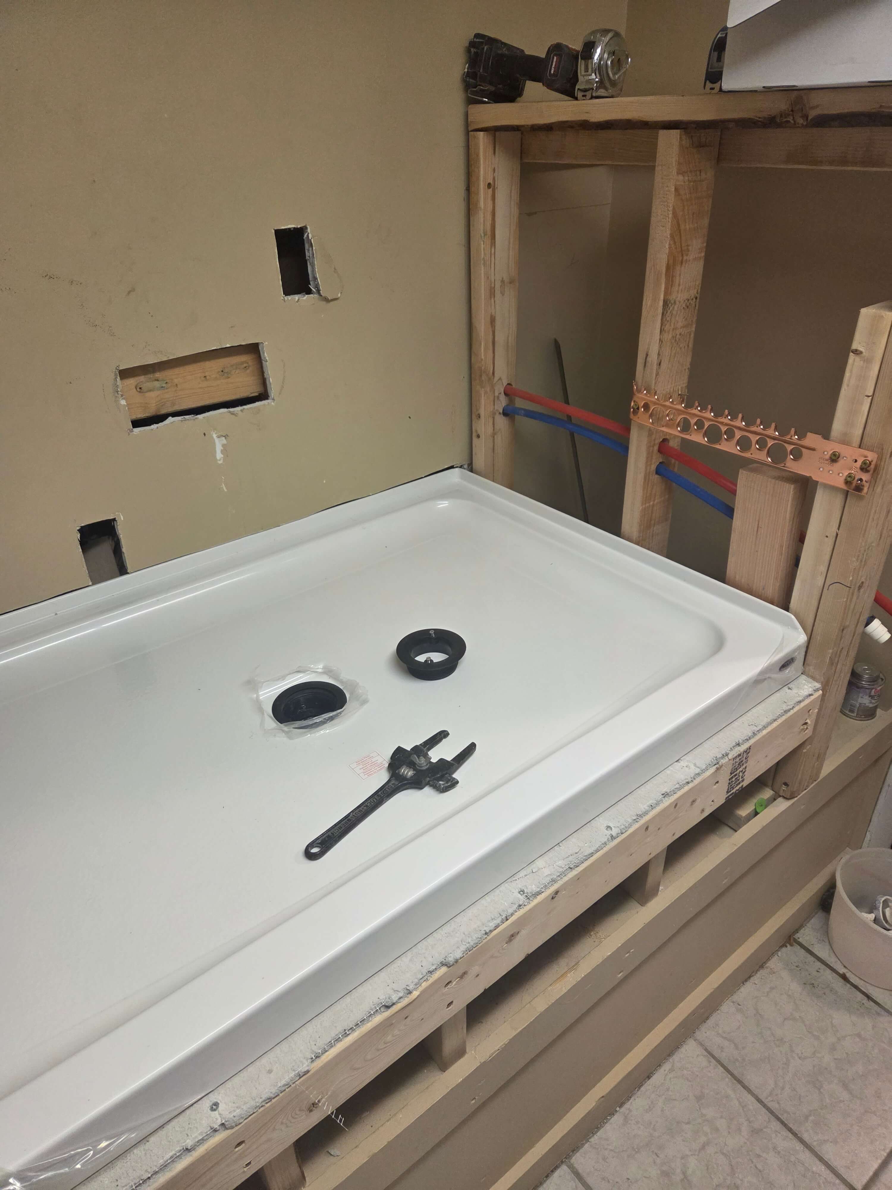 Shower pan installed on elevated platform