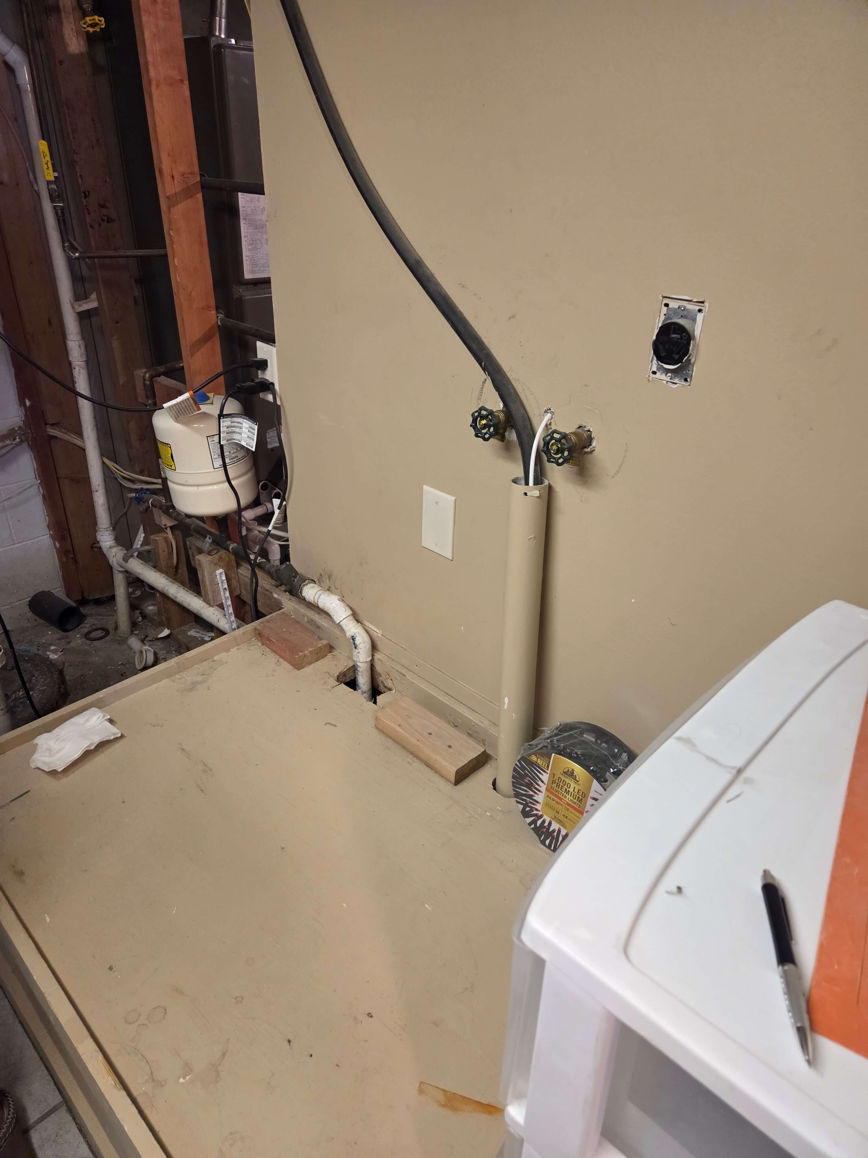 Before - old plumbing and laundry hookups