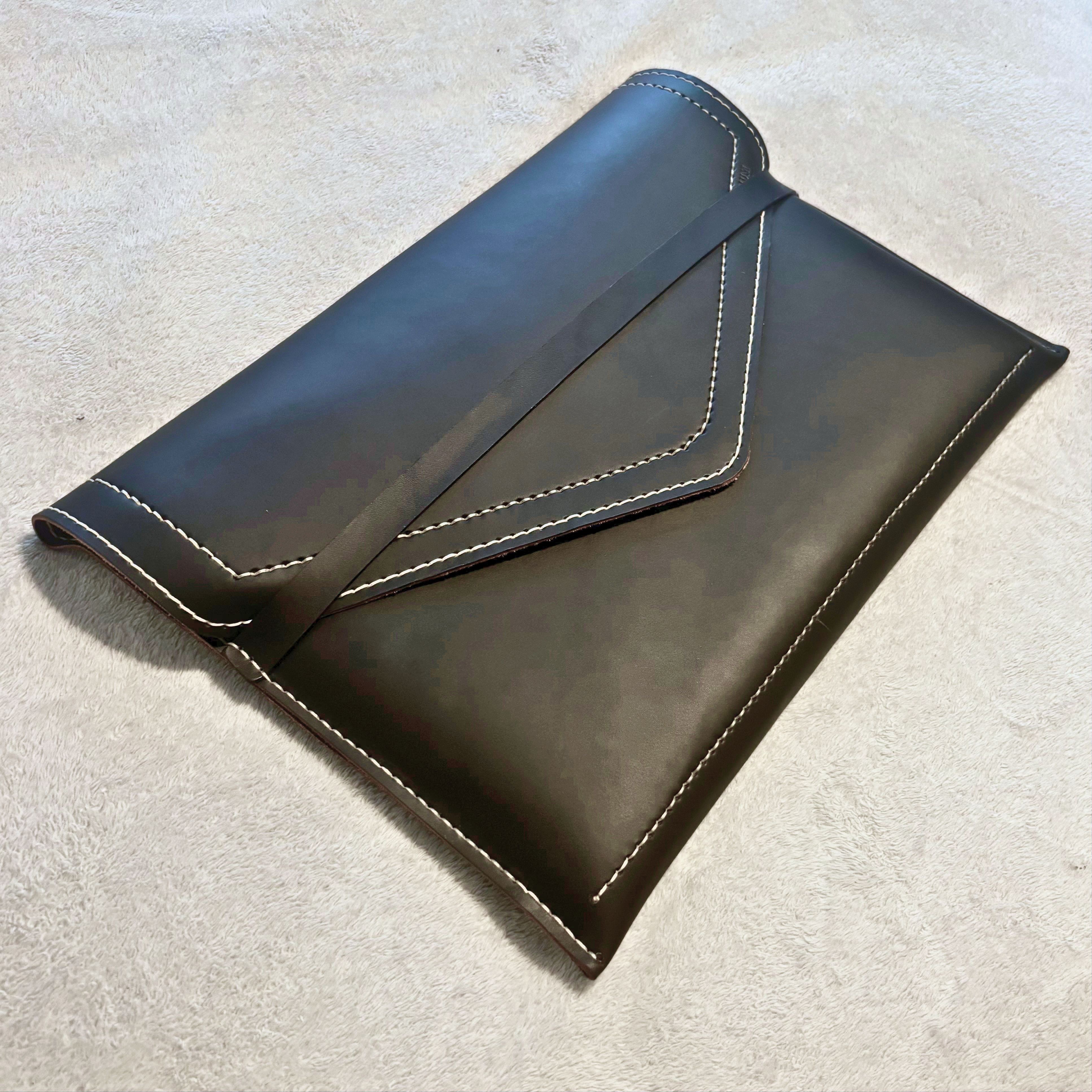 The Tailored Laptop Sleeve — closed, angled view in full-grain leather