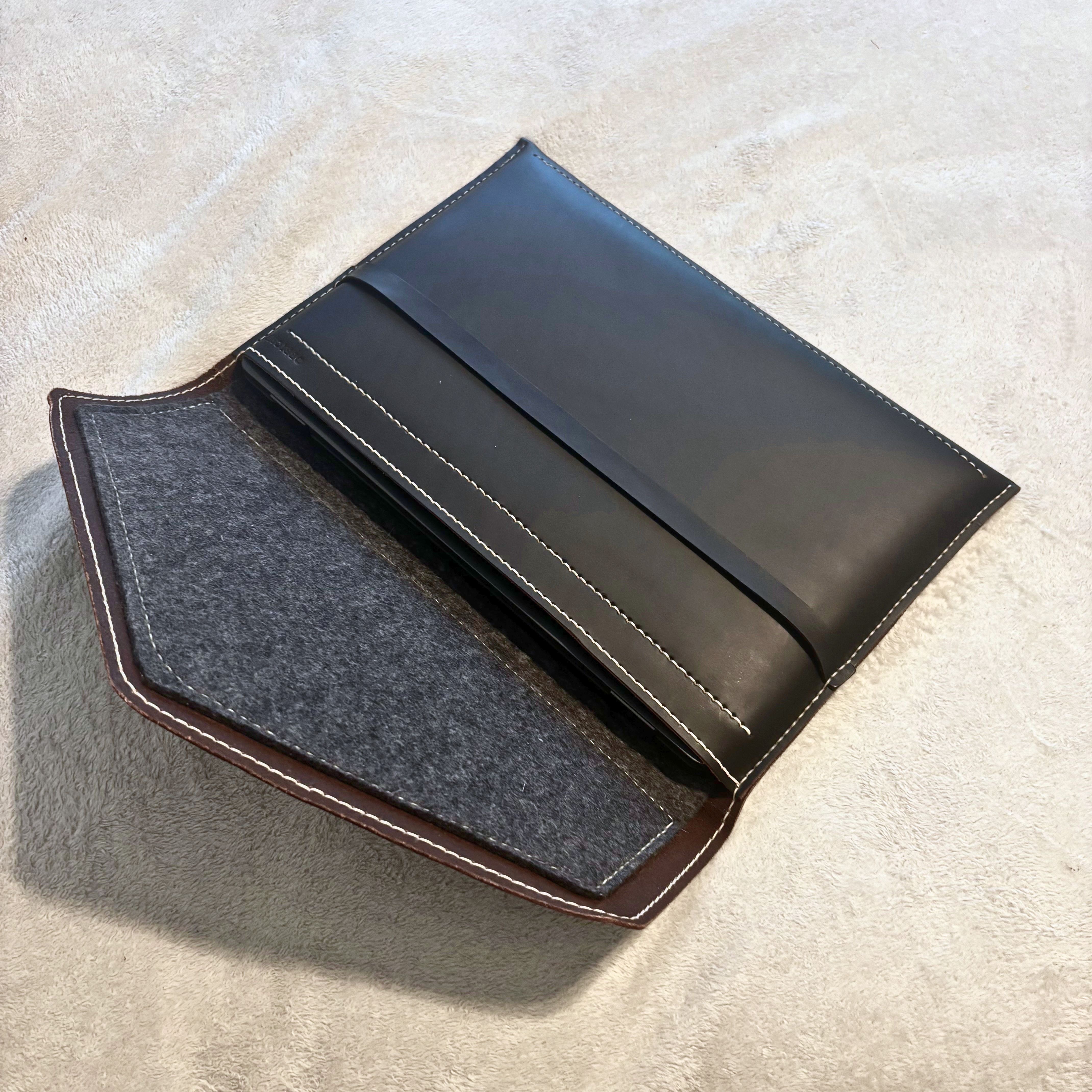 Flap open — full-grain leather exterior with wool felt interior visible