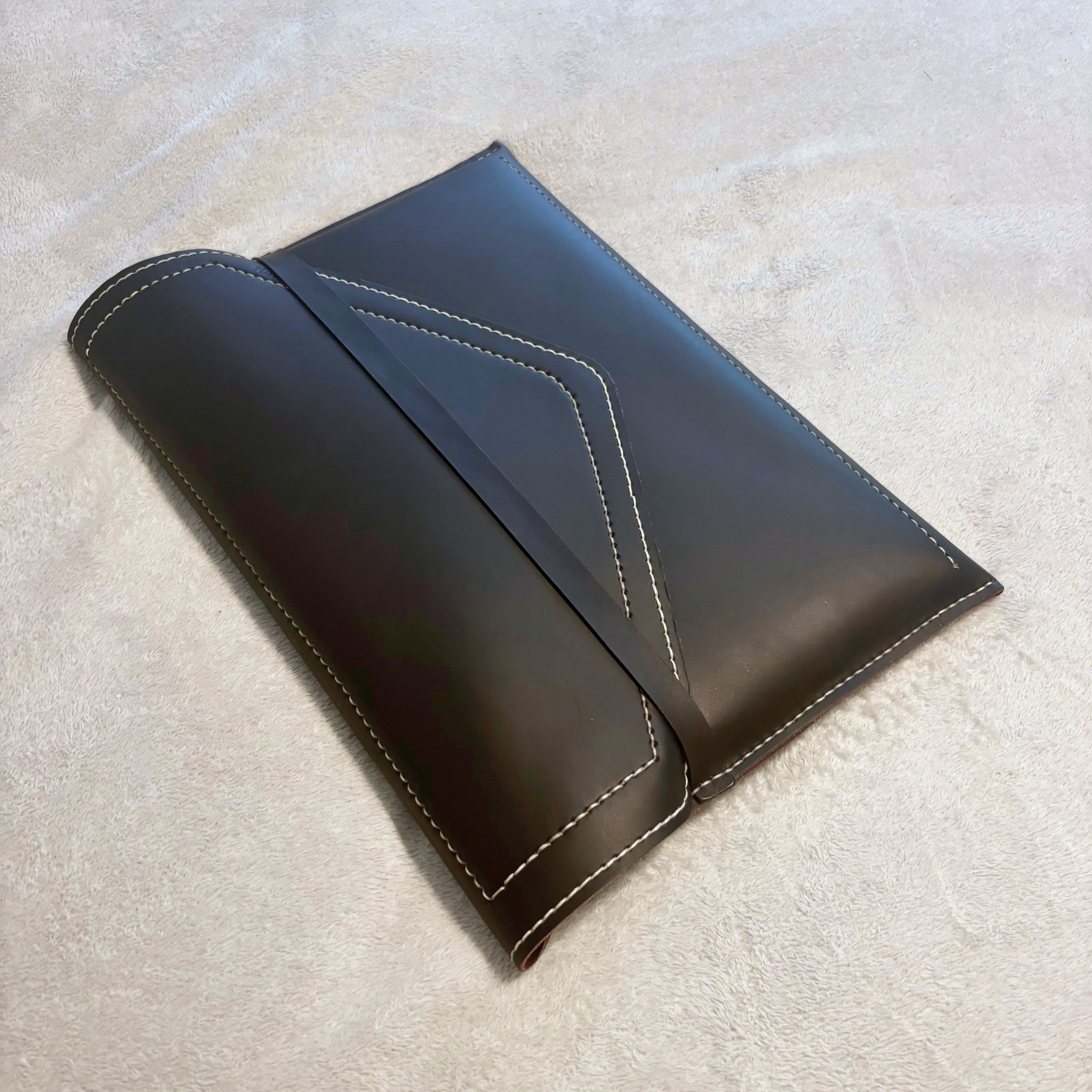 The Tailored Laptop Sleeve — front view, full-grain leather exterior