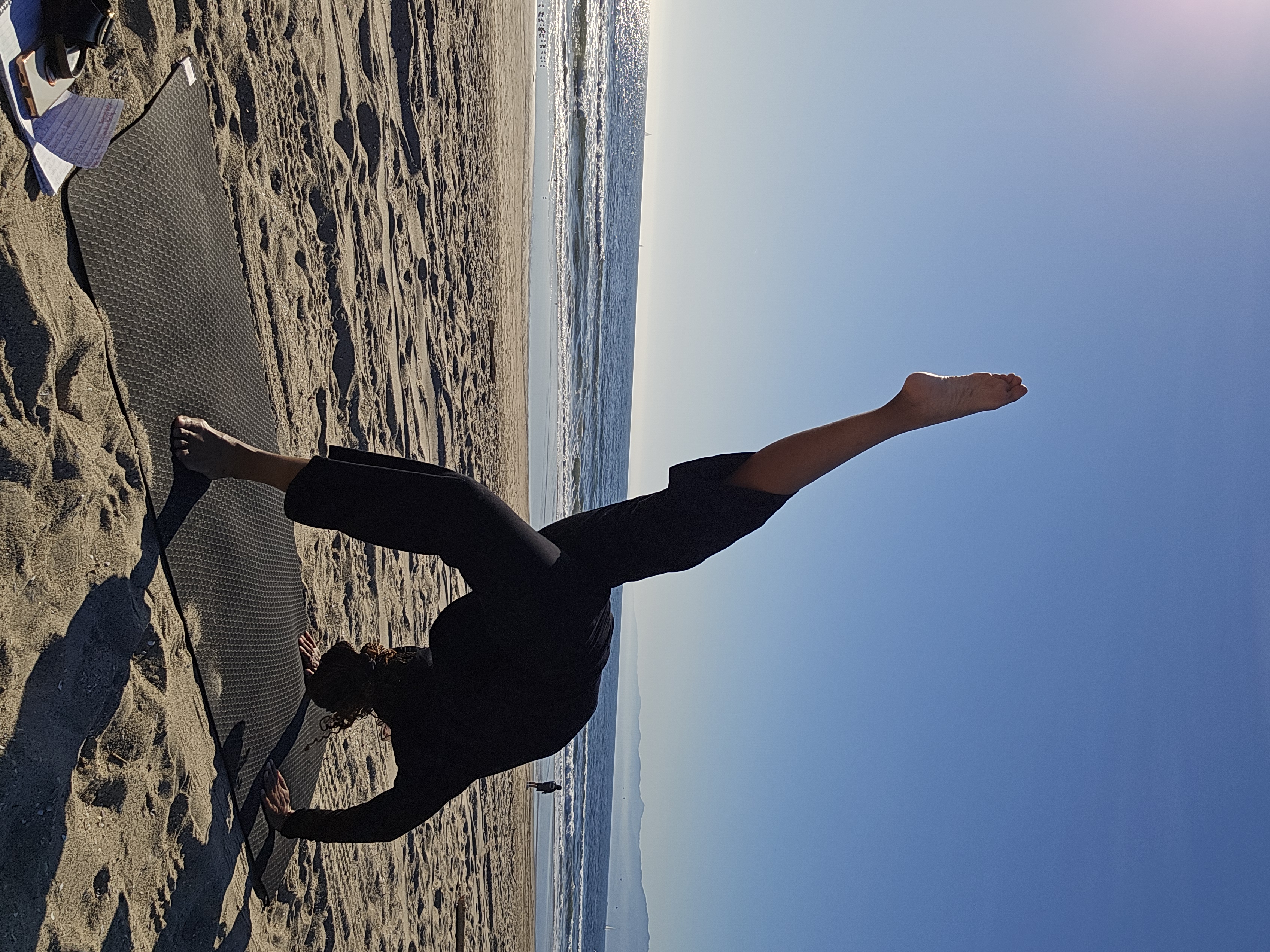 Moni in backbend silhouette on the beach
