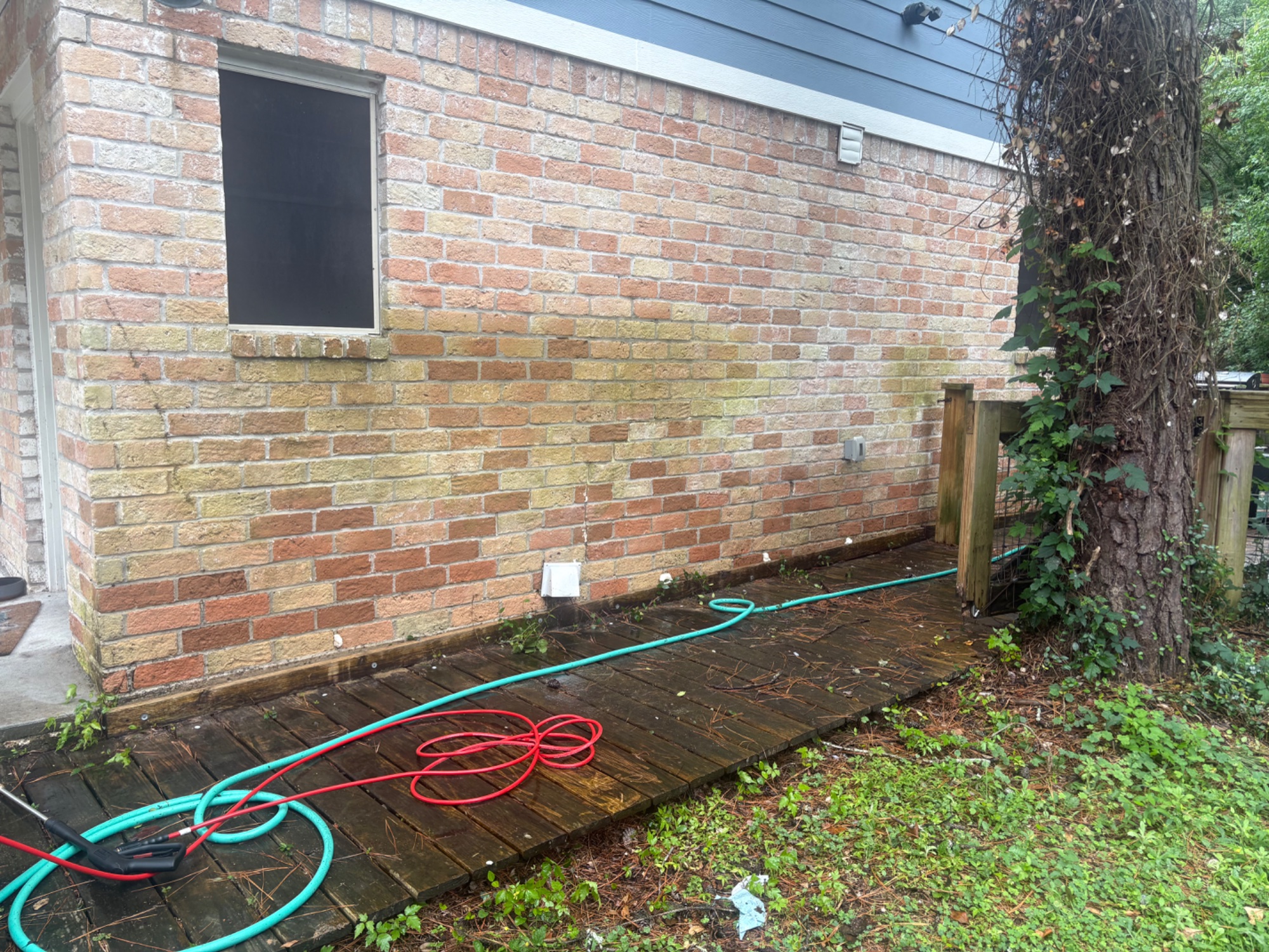 After pressure washing — clean brick wall and restored deck