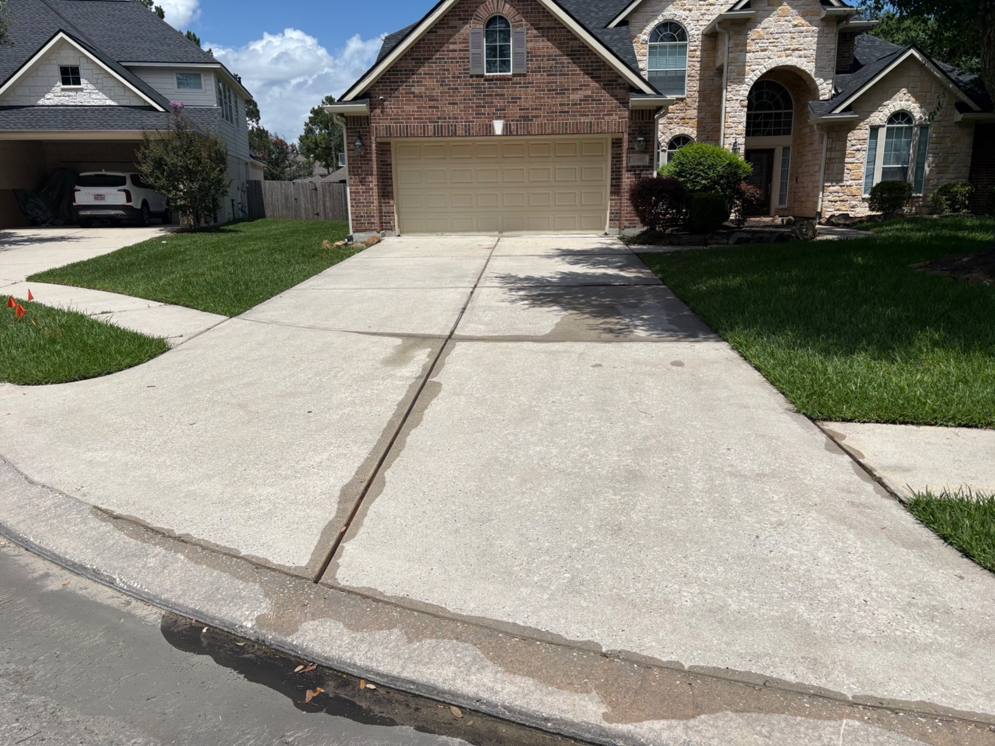 Clean suburban home driveway and exterior after professional pressure washing