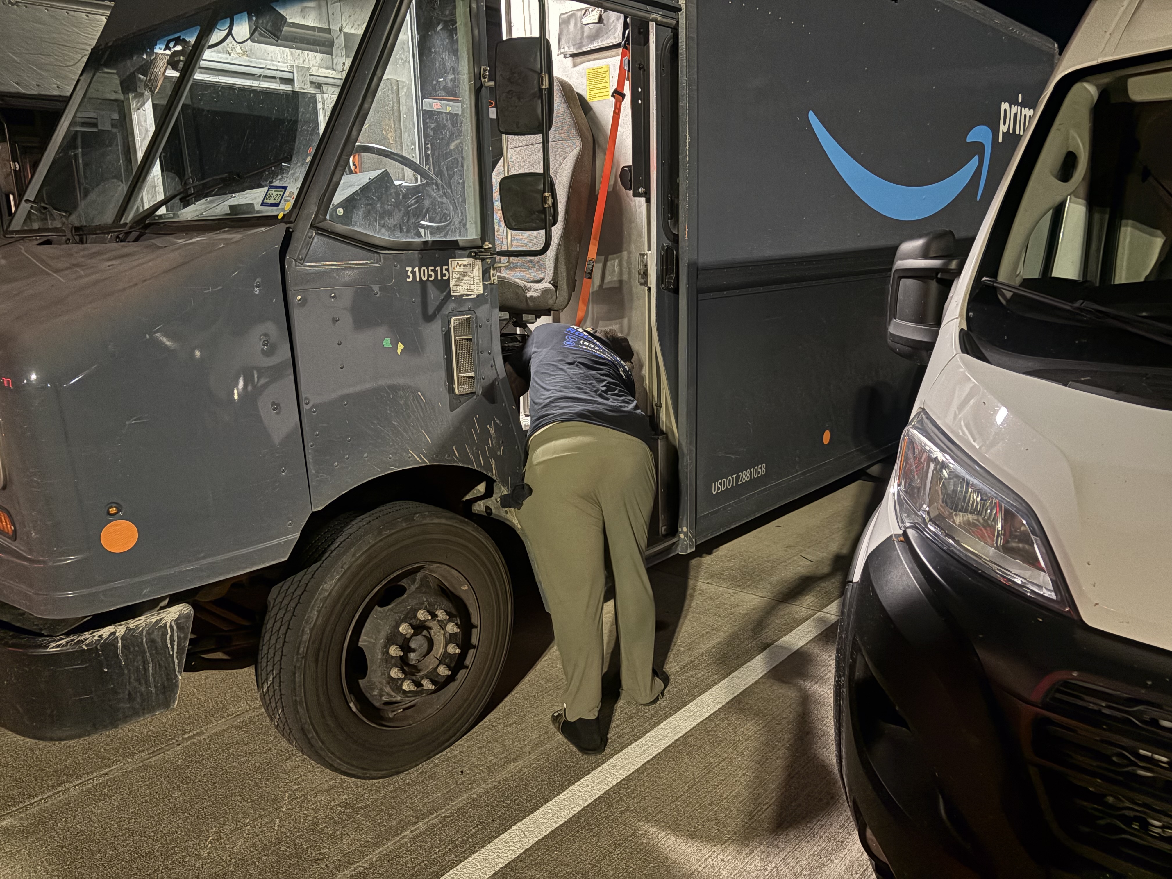 Night Shift? team member cleaning Amazon delivery step van at night — professional fleet cleaning in action