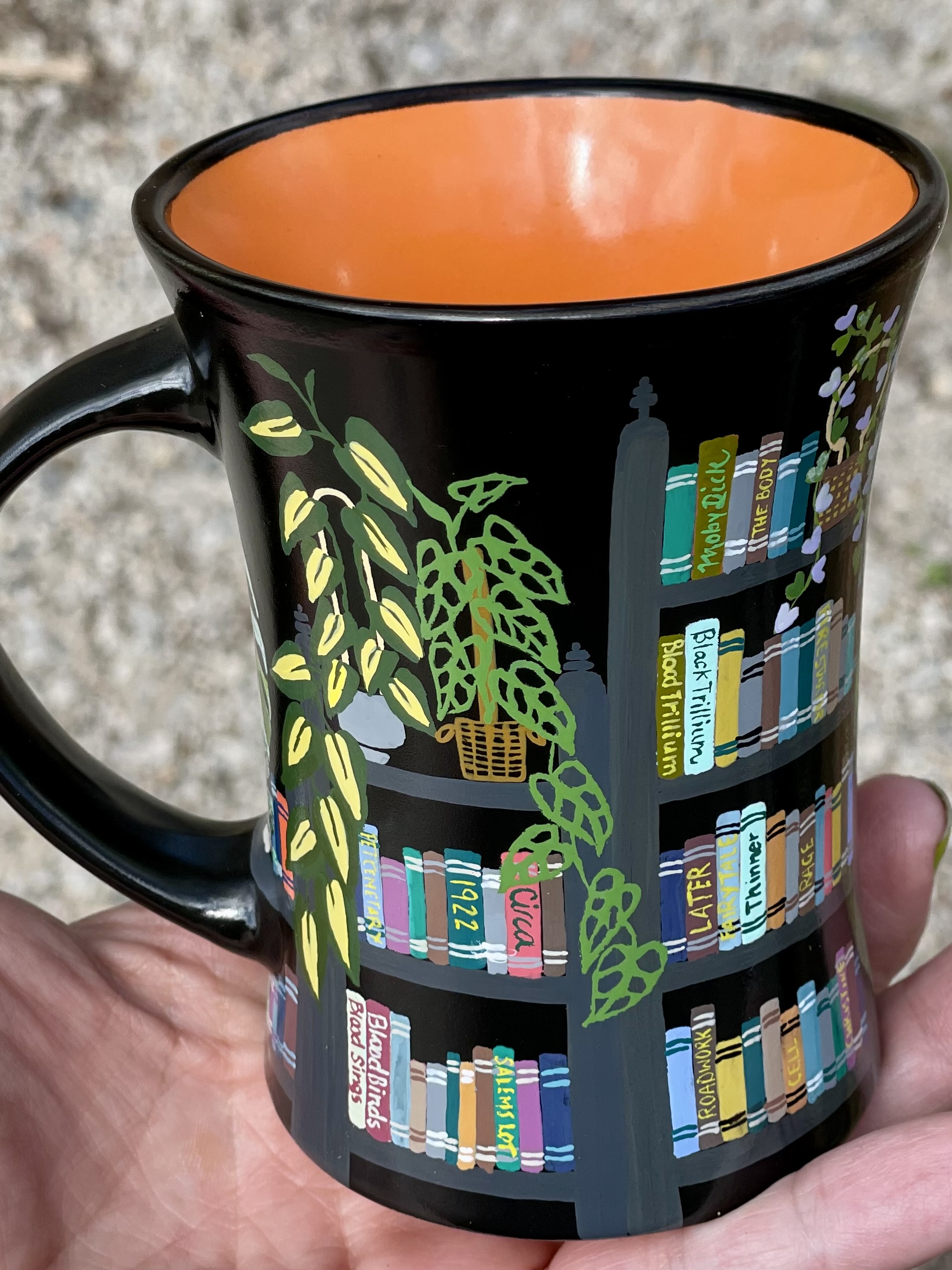 Bookshelf mug in black with hand-painted Stephen King titles