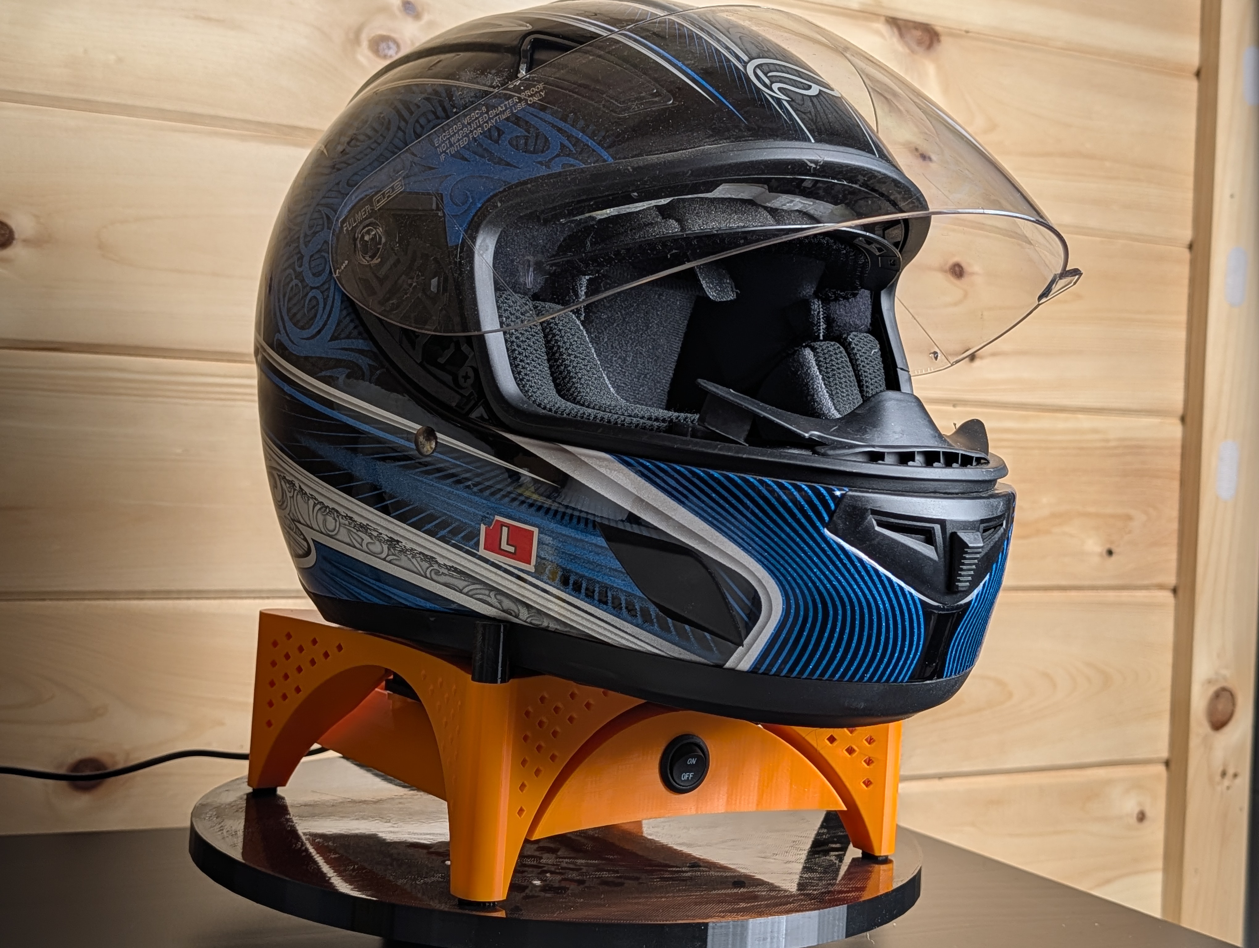 Helmet Dryer Stand — orange unit with helmet