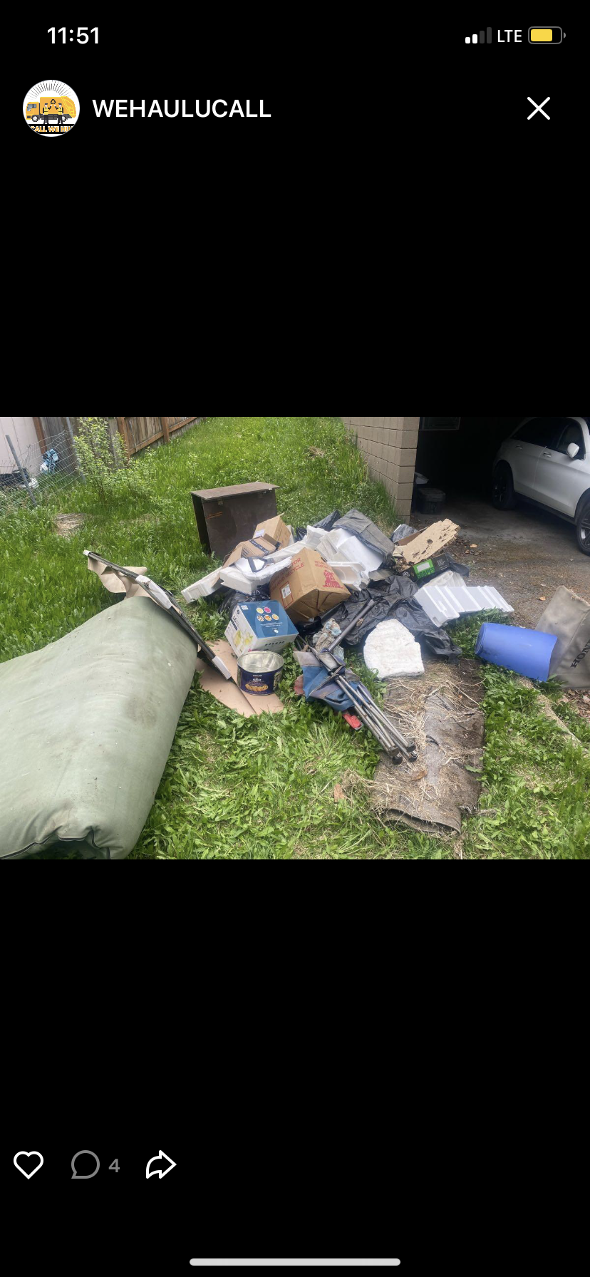 Before — Pile of boxes, styrofoam, old furniture, misc junk on grass near driveway