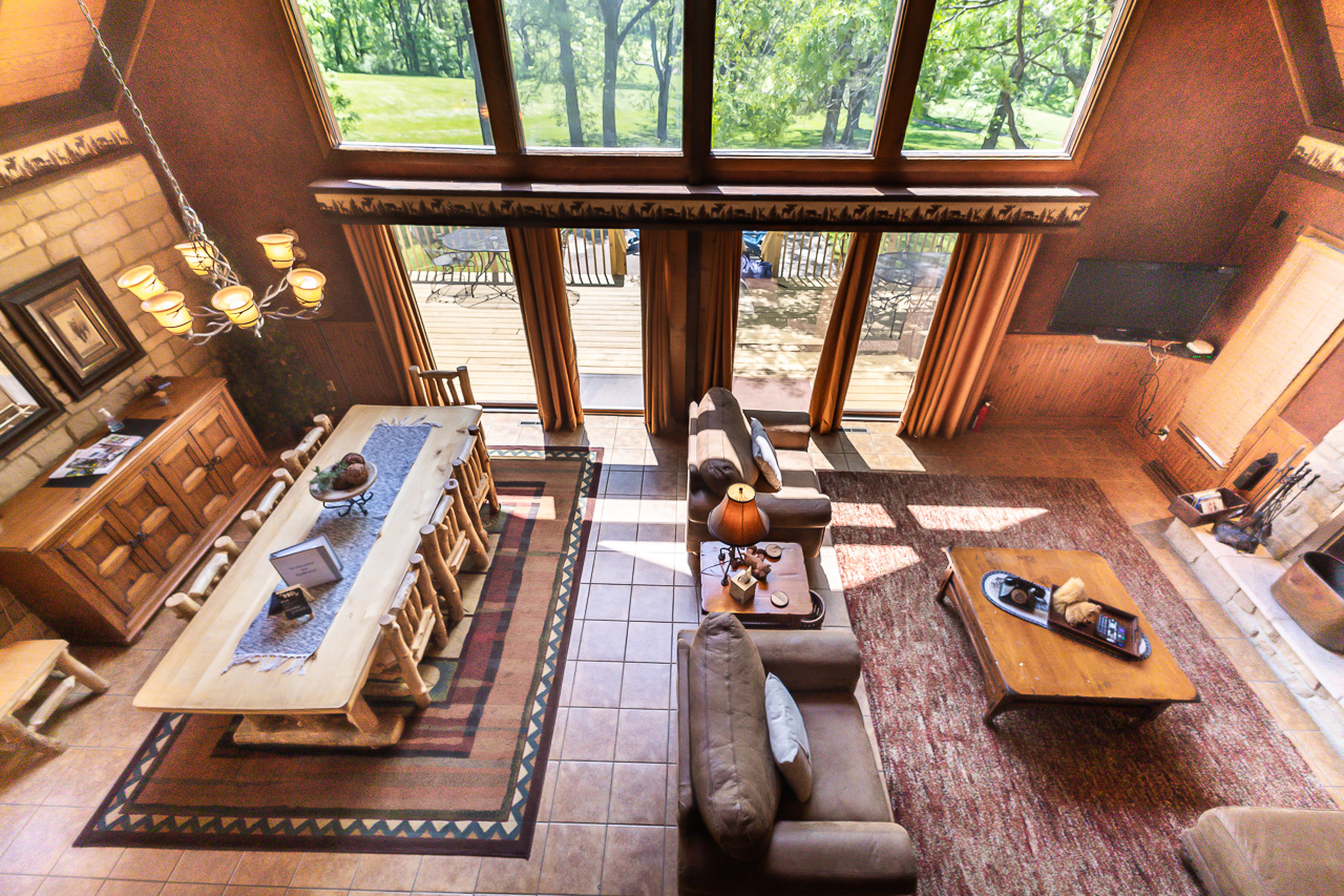 Living Room with vaulted ceilings, log furniture, and floor-to-ceiling windows