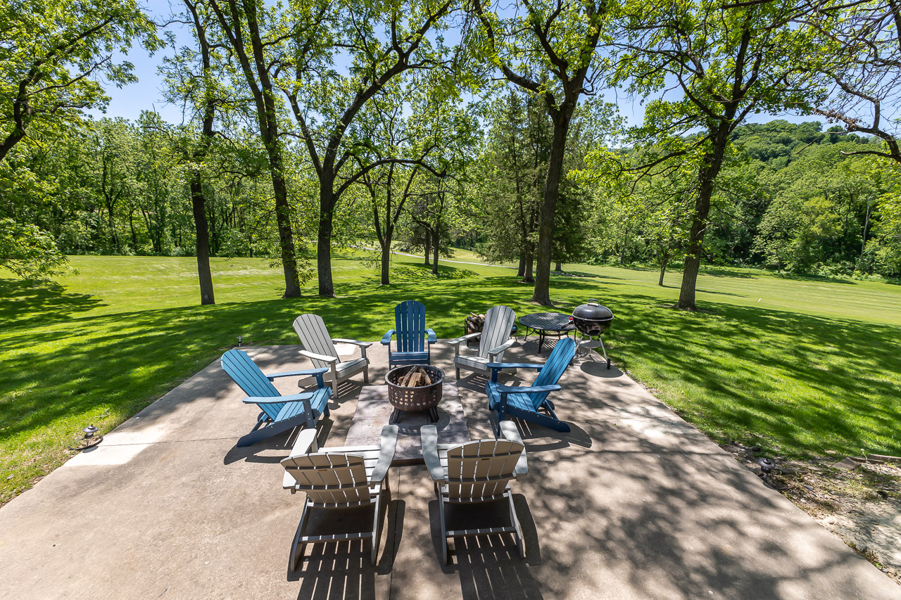Fire Pit and Yard with Adirondack chairs, Weber grill, and mature trees