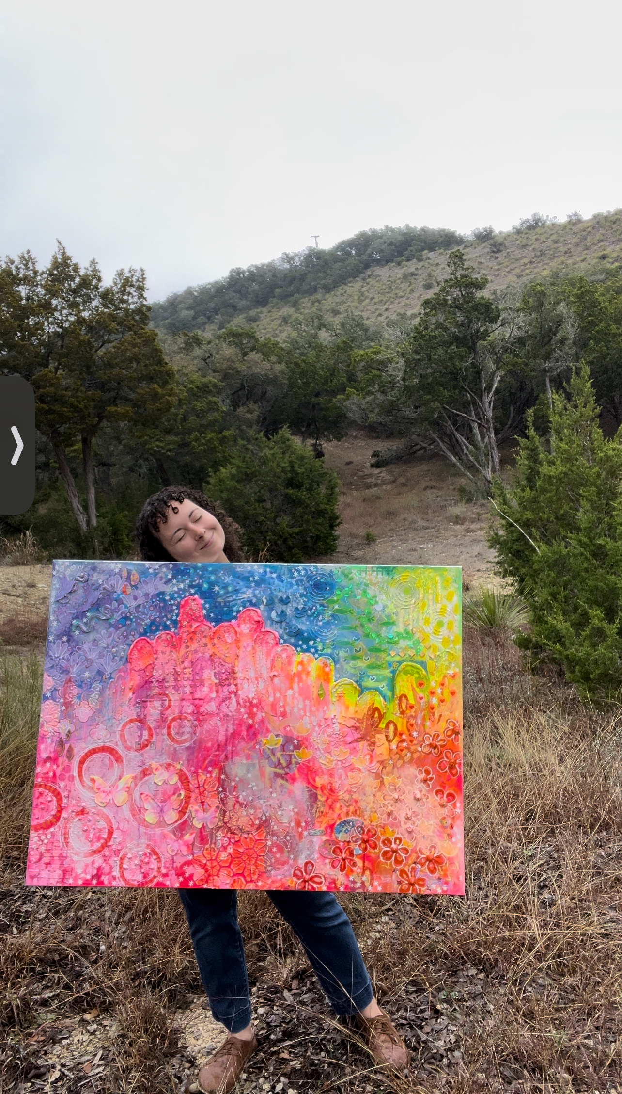 Erin GoodLife holding her natural art outdoors