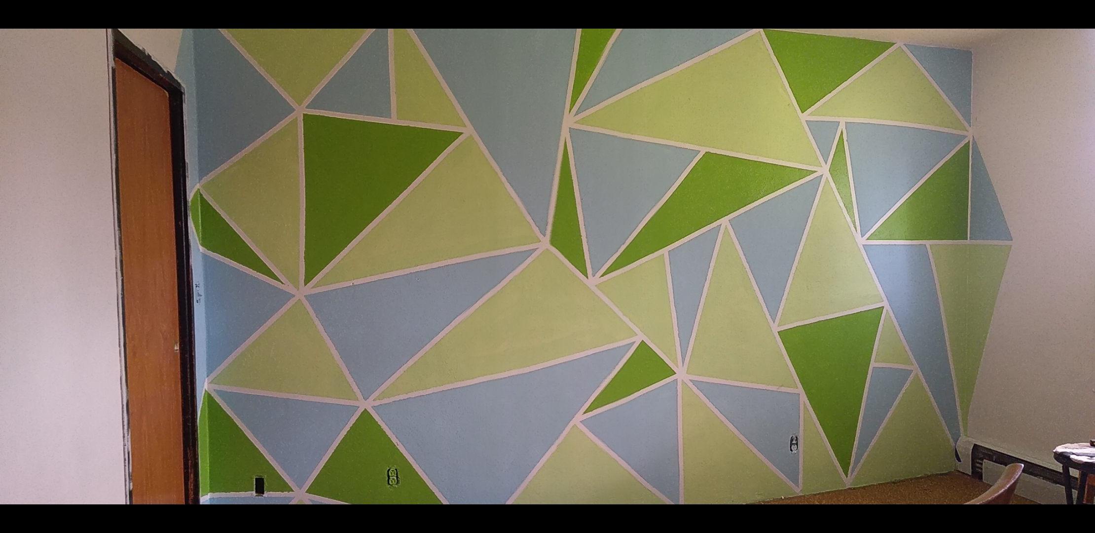 Geometric Accent Wall — painted triangle pattern on interior wall