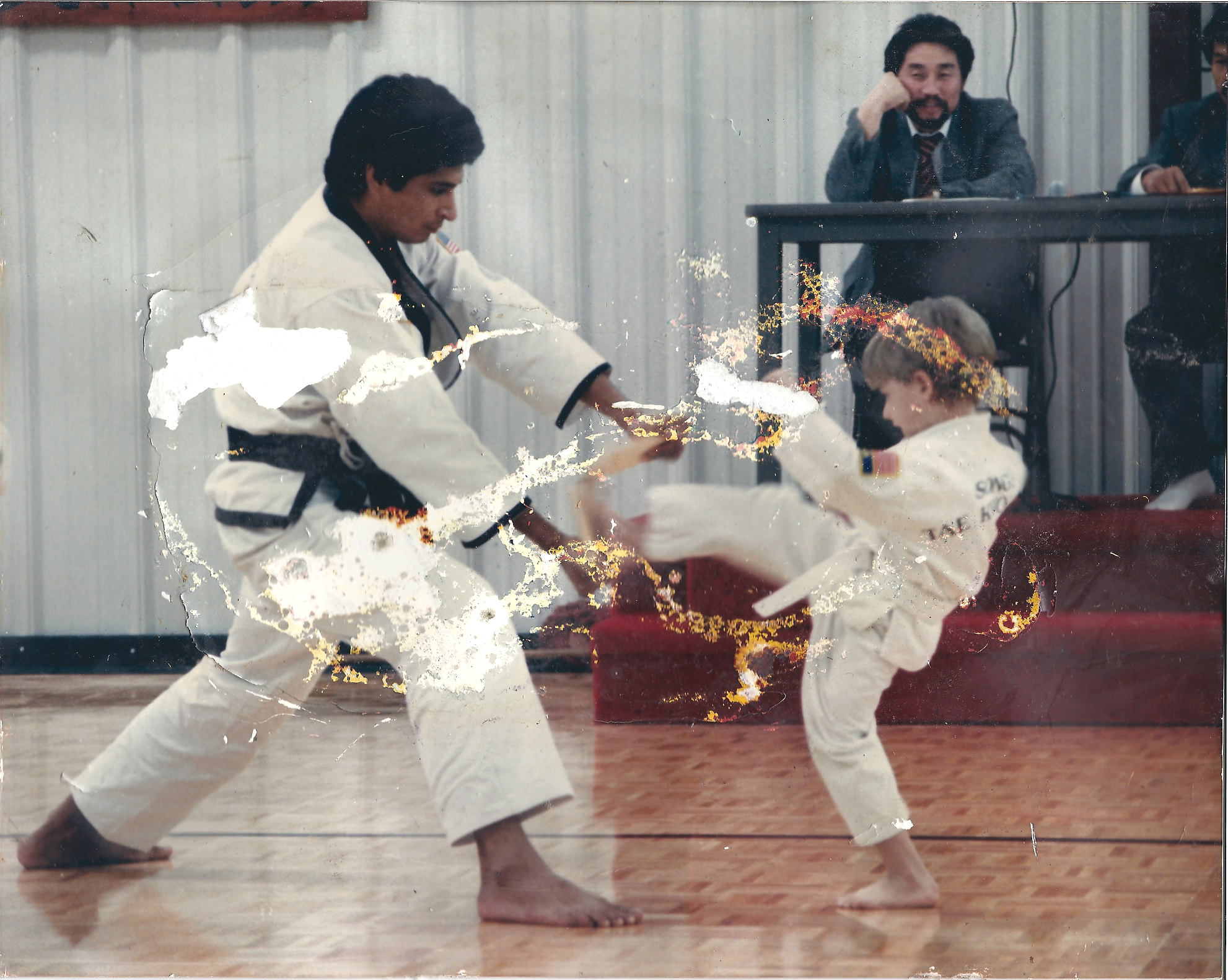 Before restoration — 1980's Taekwondo family picture with water damage from flooded basement