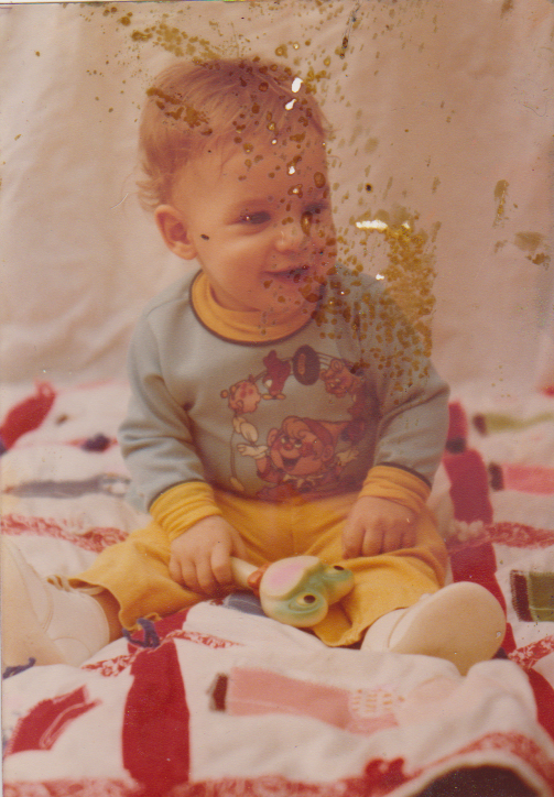 Baby portrait before restoration — spots and stains on face