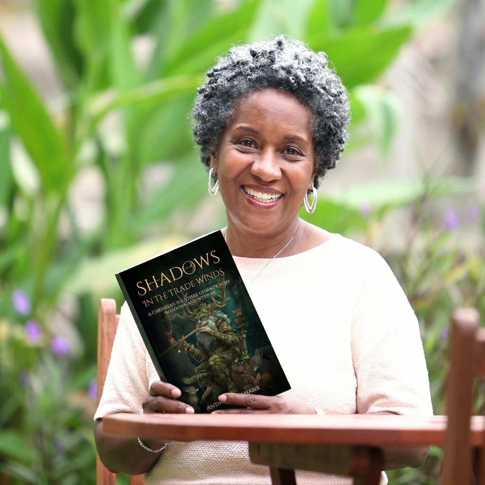 Reader enjoying Shadows In The Trade Winds in a tropical garden
