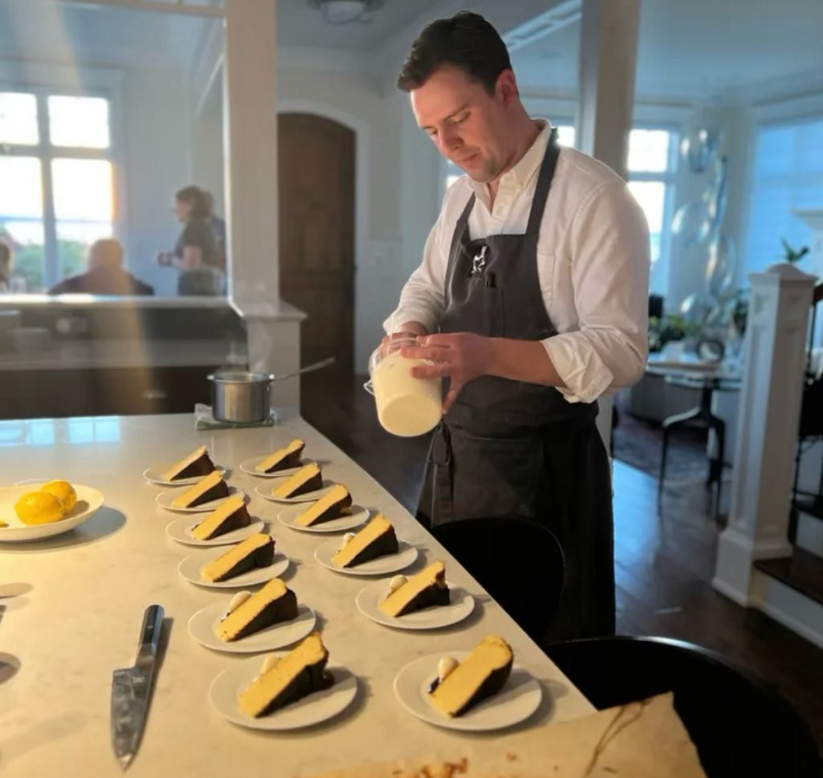 Chef Ryan McLaughlin plating a course for a private dinner event