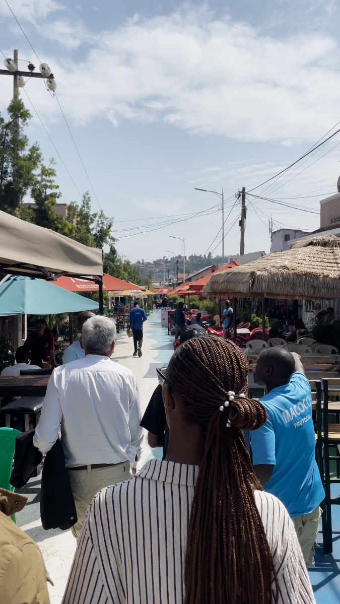 Walking through outdoor cafe area in Nyamirambo