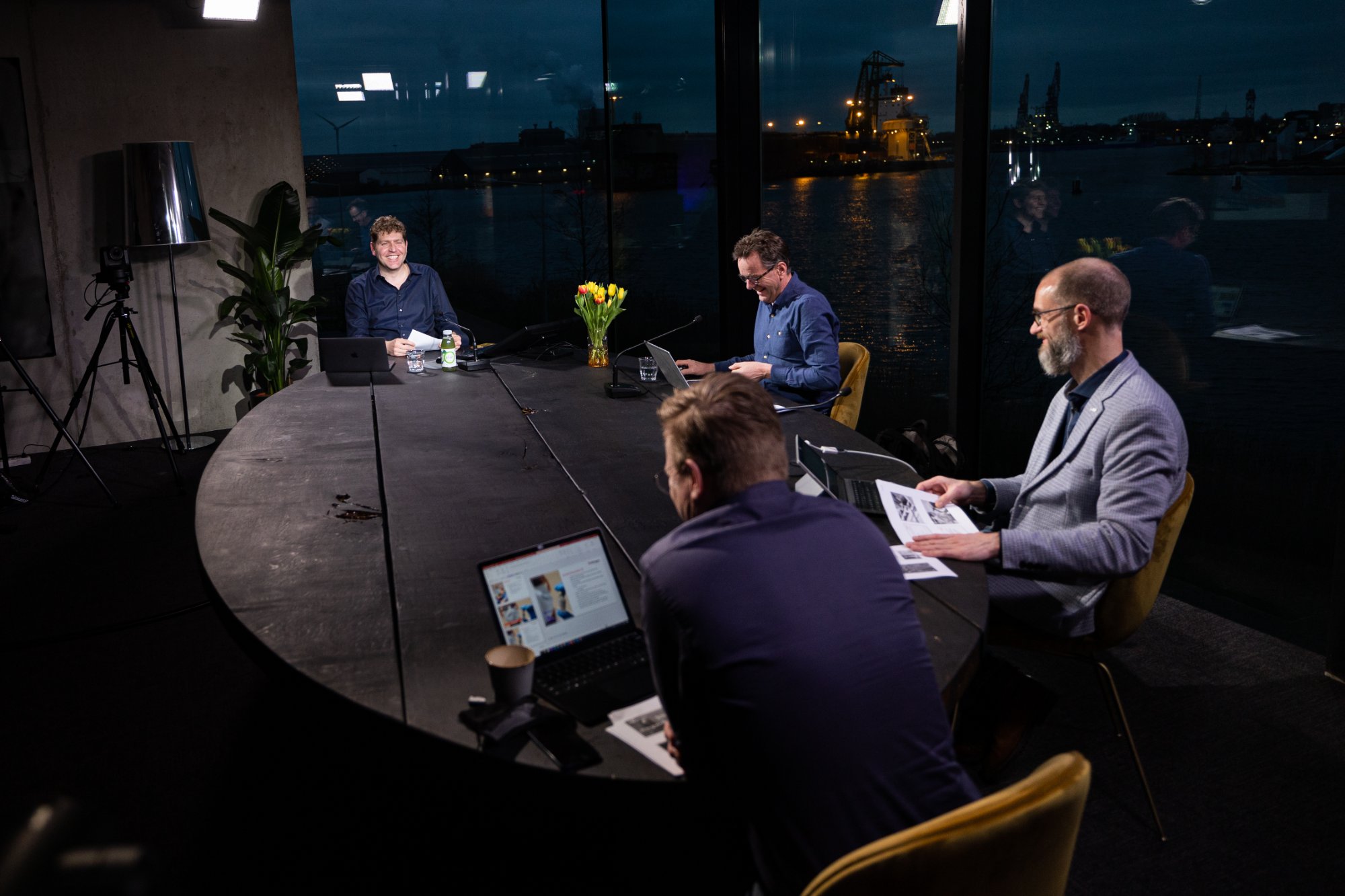 Crowdale studio — 4 people working at the Amsterdam IJ waterfront at night