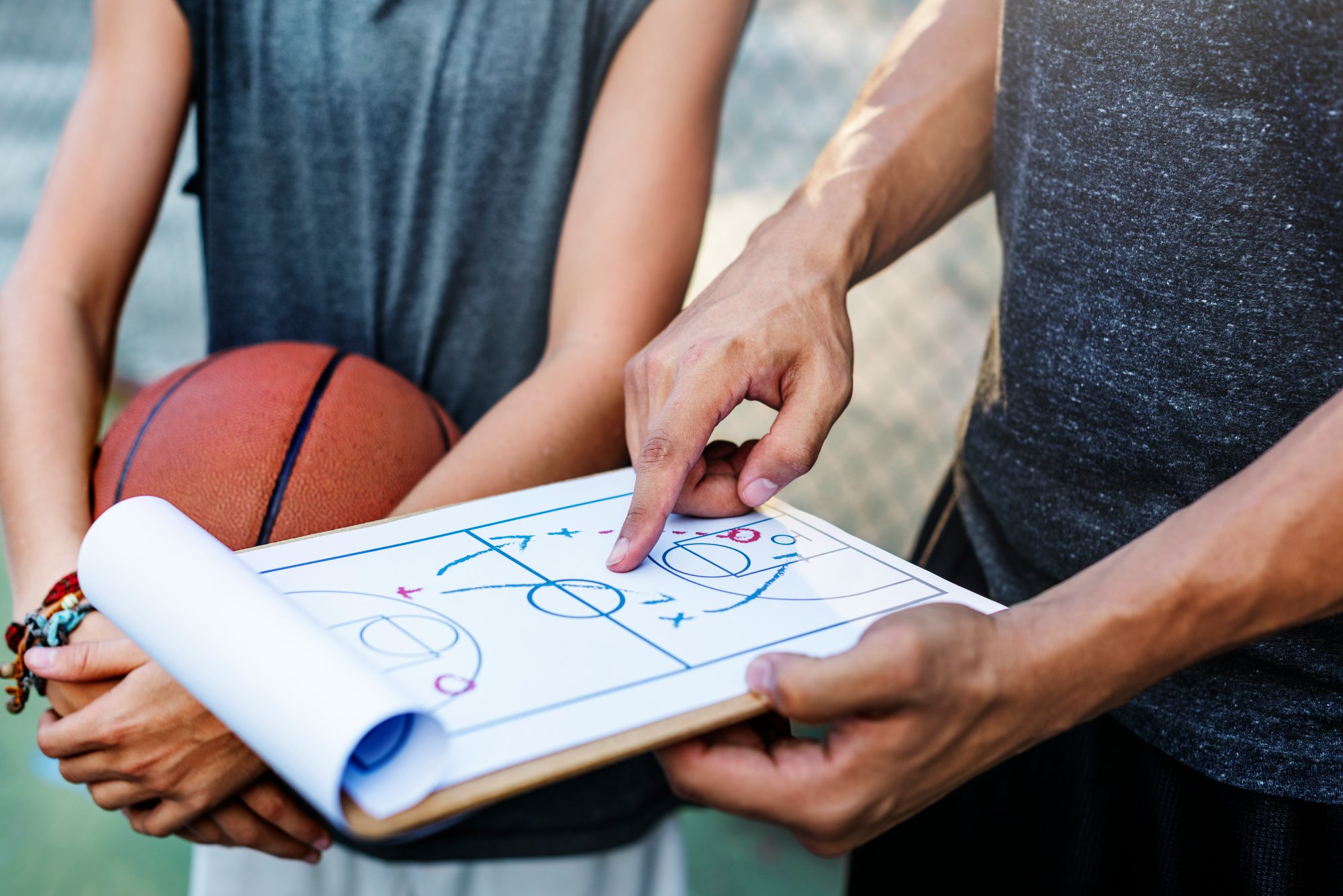 Coach and athlete reviewing playbook