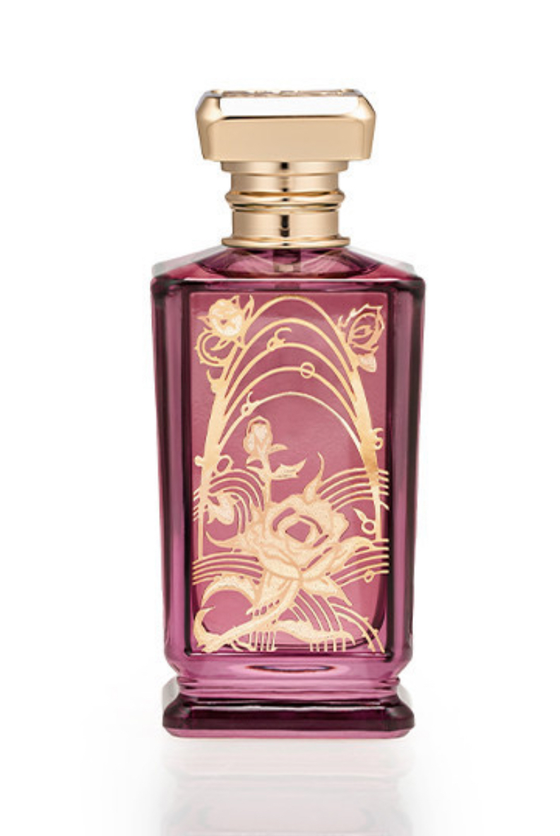 REVERIE ROSE — amber-red perfume bottle with gold botanical relief