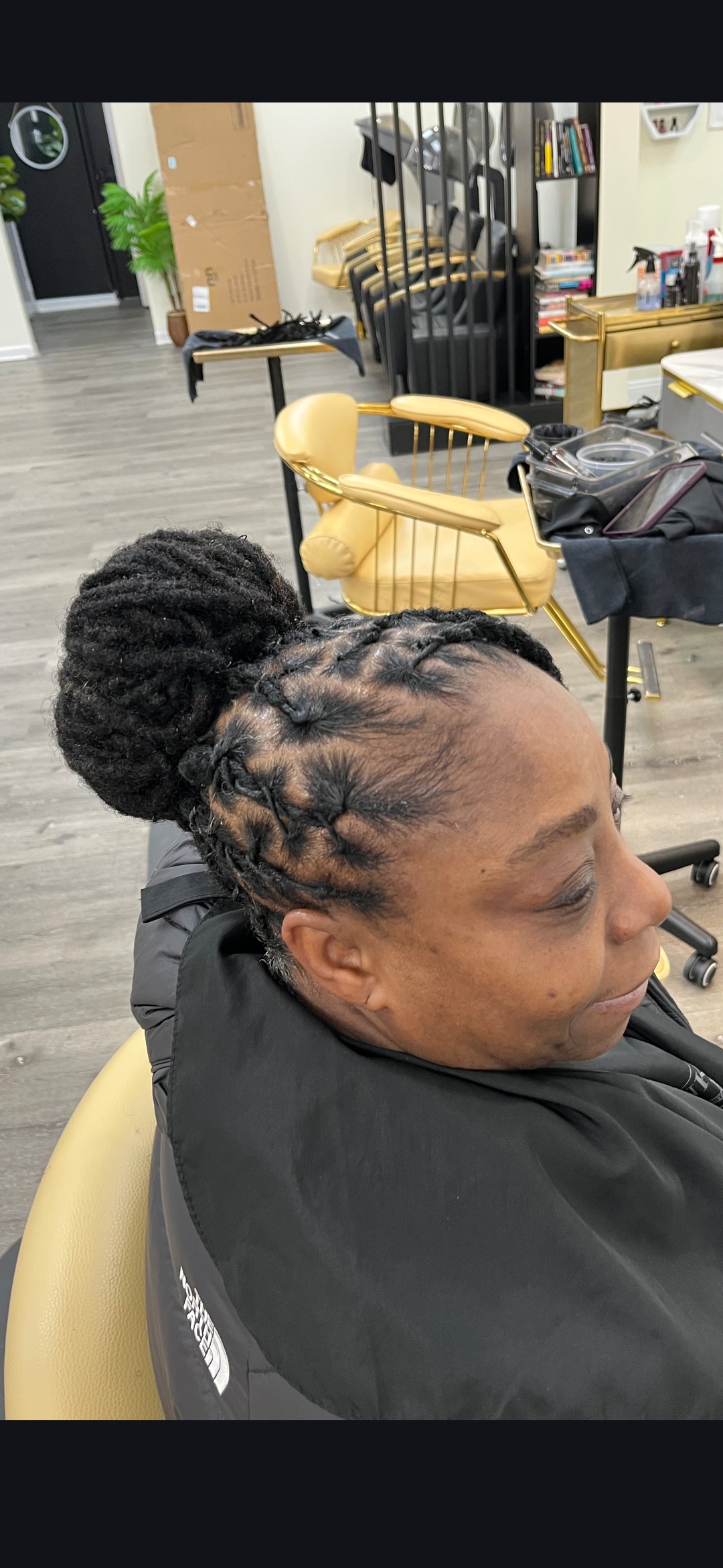 Loc updo bun side profile — loc styling services at Sinkor Beauty Salon Delaware