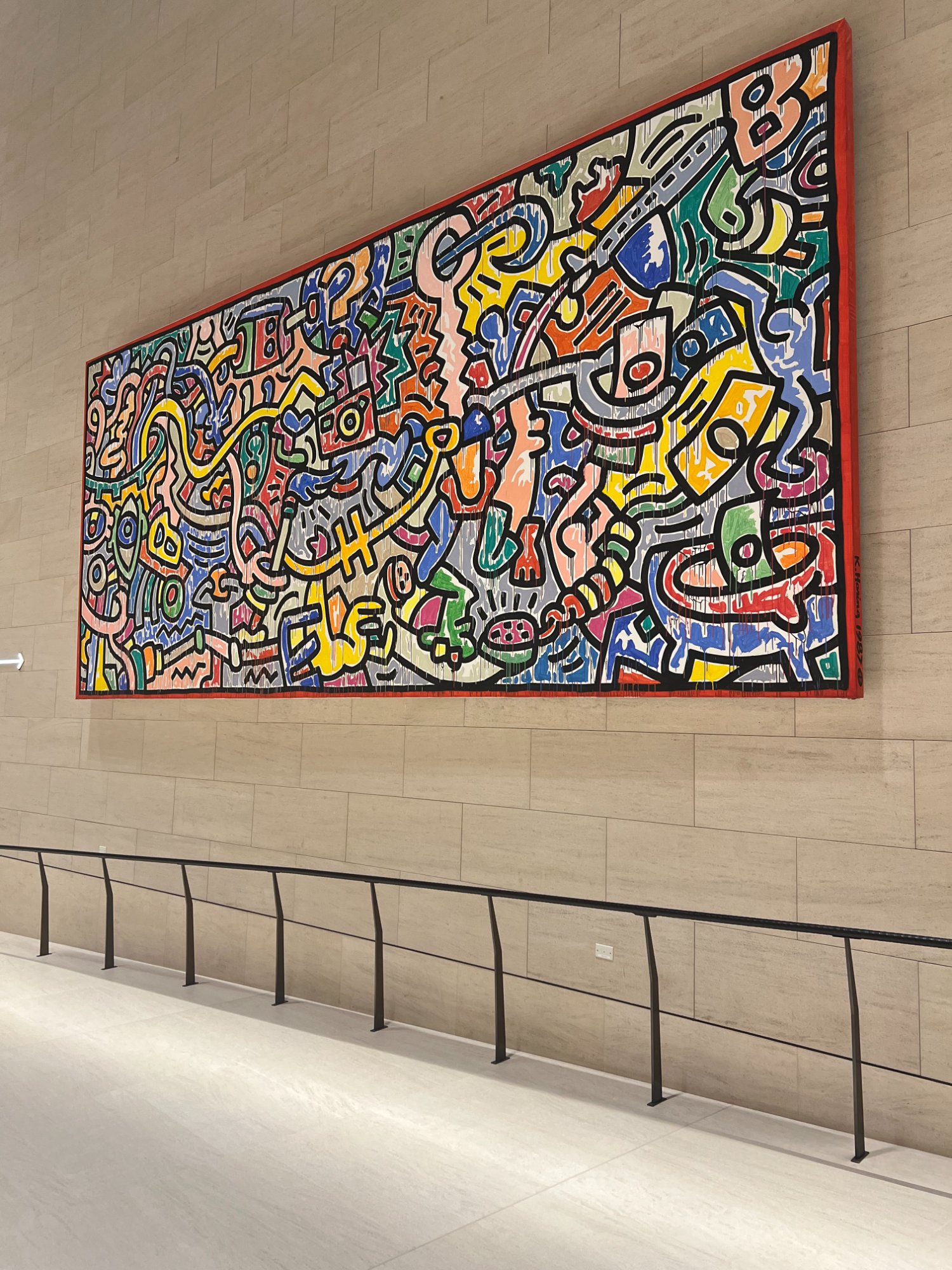 Keith Haring artwork mural displayed inside Hamad International Airport terminal in Doha