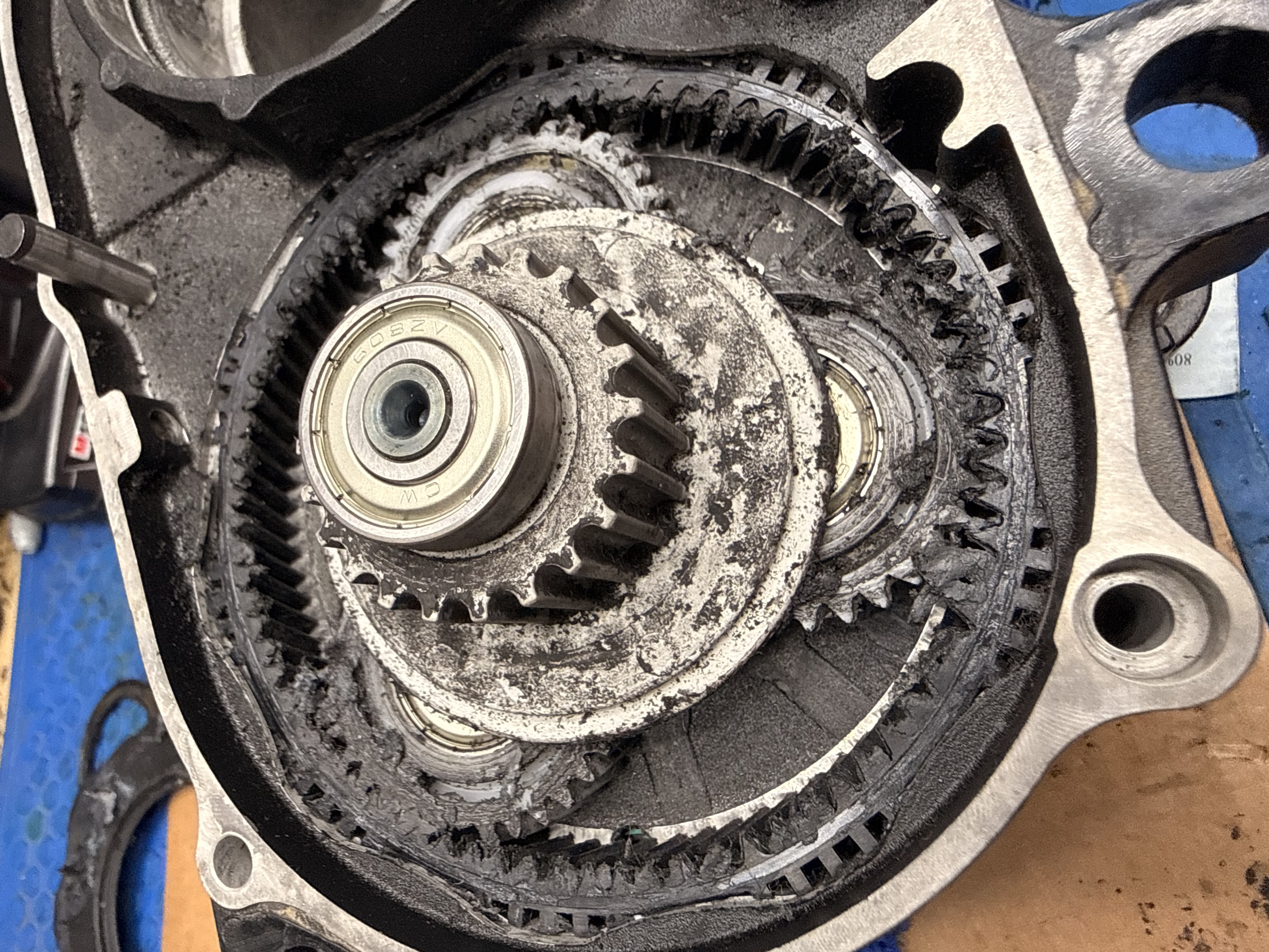 Open motor housing with internal drive components visible during teardown