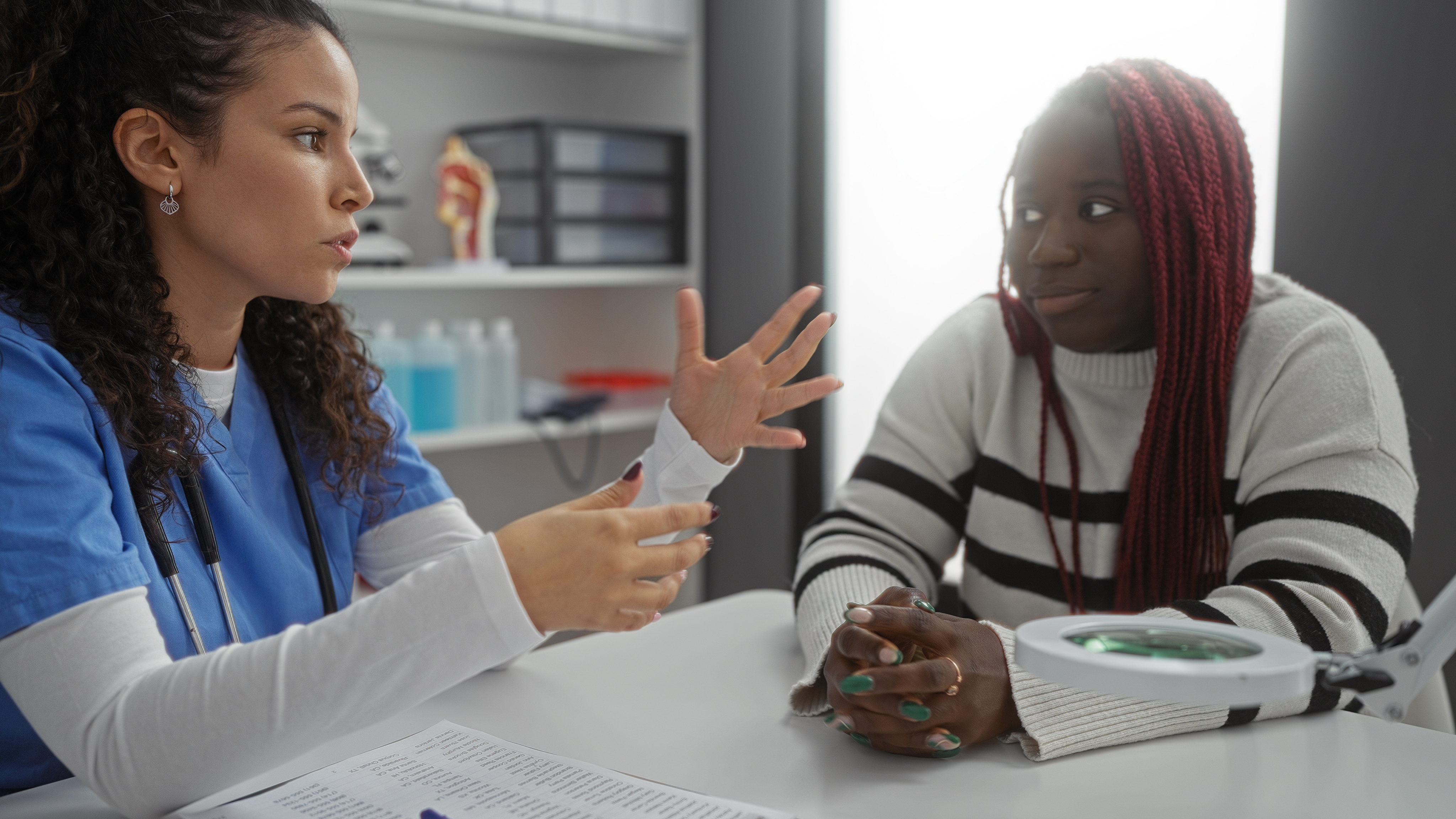 Expert medical professional in scrubs consulting with patient at NewU