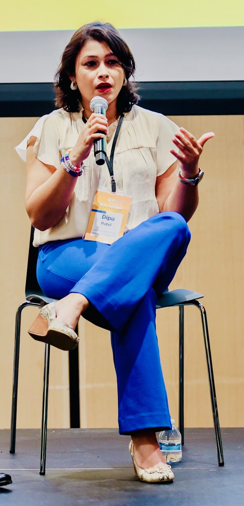 Dr. Patel — Speaking with microphone on stage