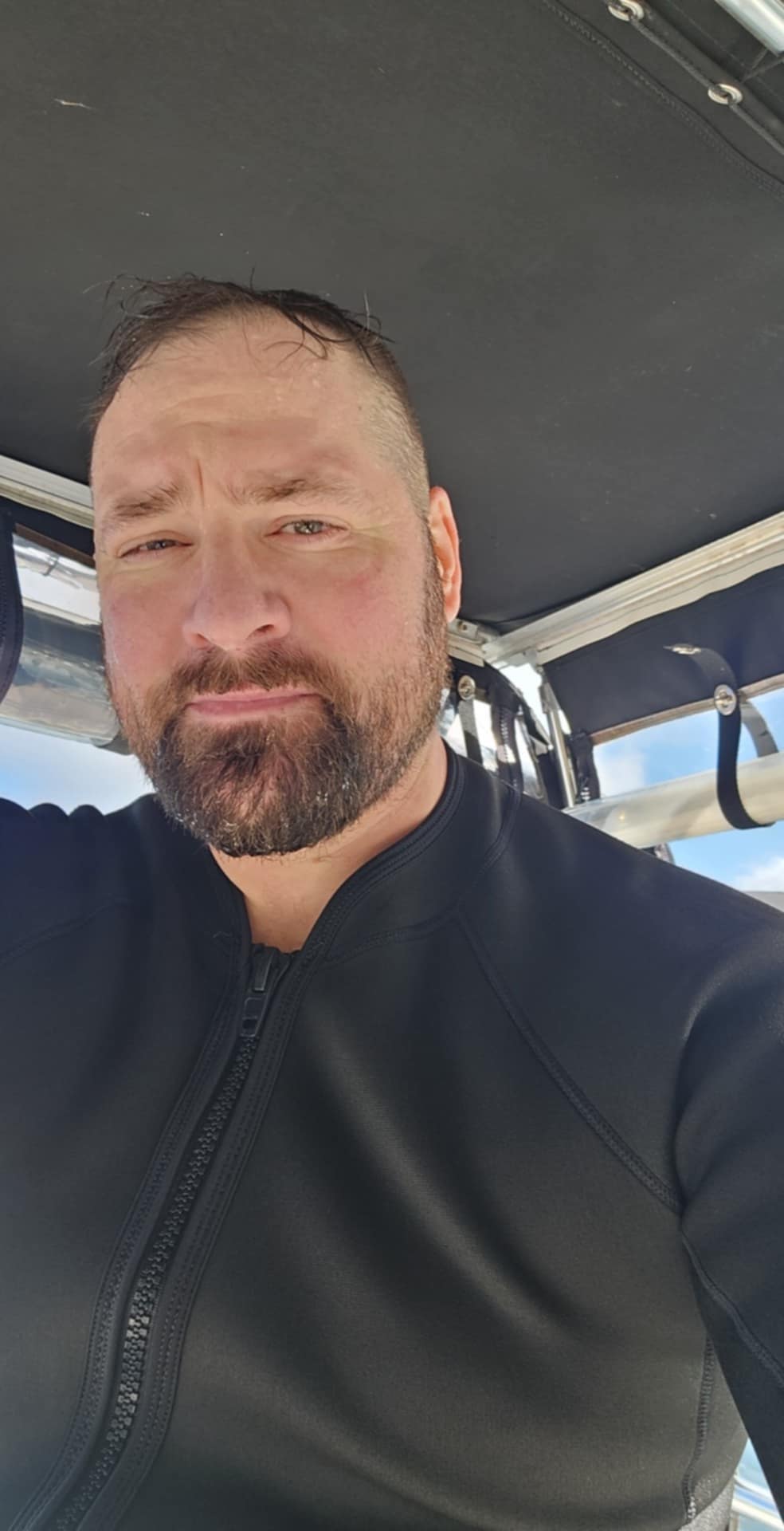 Mike on a boat, facing the camera.