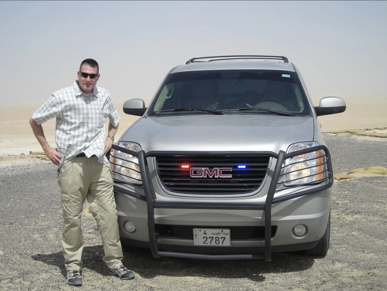 Mike standing beside an SUV.