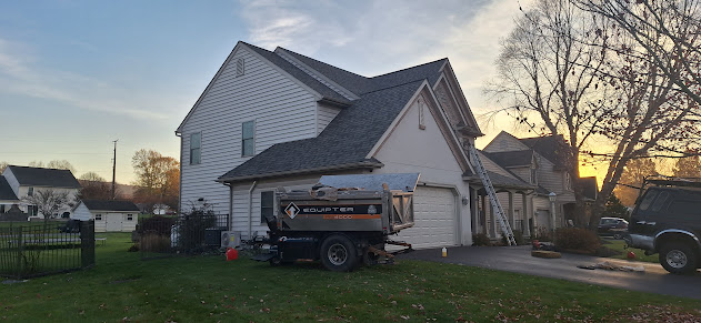 Professional Equipter debris trailer on-site at residential roofing job — front view showing clean job site setup