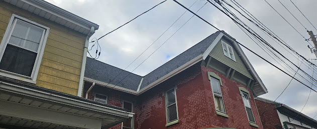 Completed roof replacement street view on downtown Victorian — new shingles visible from sidewalk Lebanon PA