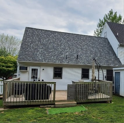 Completed Cape Cod roof back view — finished shingles from backyard, clean and watertight