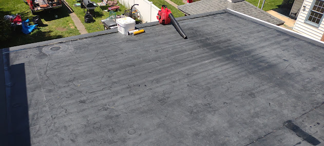 Completed EPDM flat roof replacement — clean rubber membrane installed with sealed penetrations and flashing