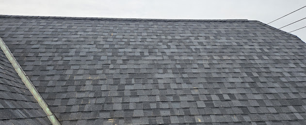 Full roof face with new architectural shingles on brick Victorian home — completed roof replacement Lebanon PA