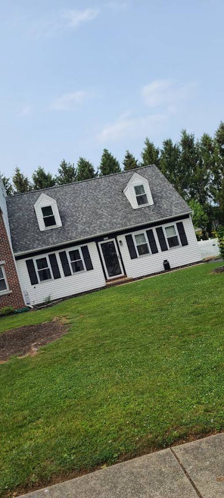 Completed Cape Cod roof front different angle — full front elevation with new shingles across all planes