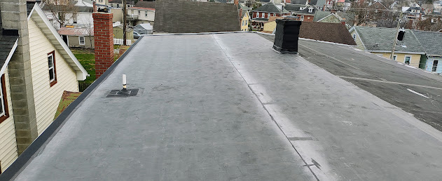 EPDM flat roof membrane from opposite angle in Ephrata PA — plumbing vent boot sealed and watertight