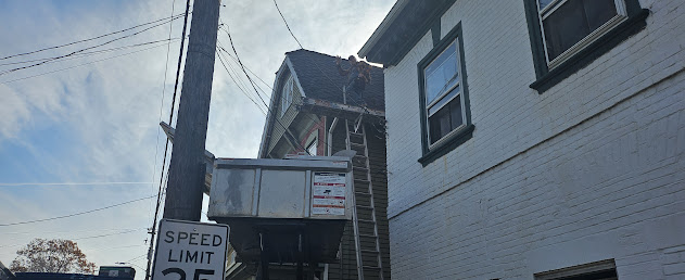 Equipter repositioned between buildings at tight urban Victorian job site — Lebanon PA roofing crew on-site