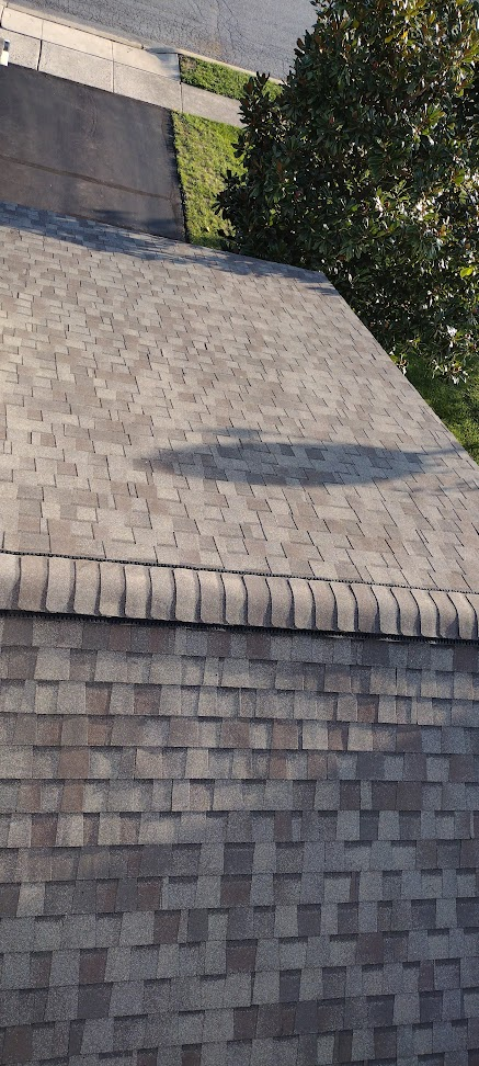 Multiple roof planes on completed architectural shingle replacement — aerial view of upscale home roofline