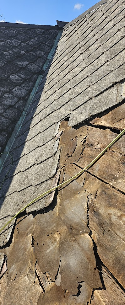 Rotted plywood decking exposed under old asbestos shingles — deck repair needed before new shingles Lebanon PA